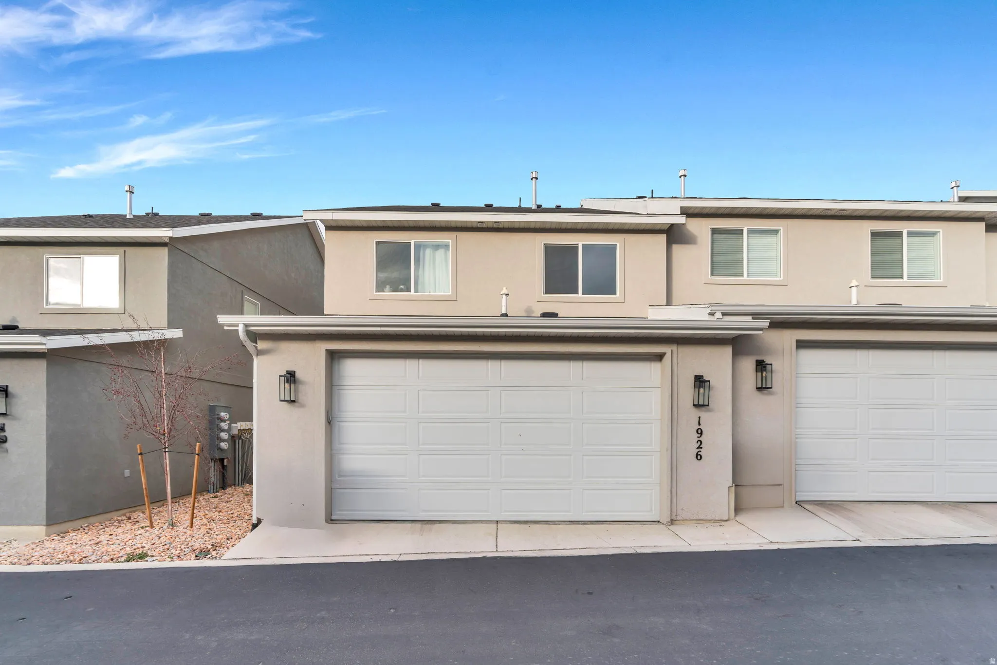 Traditional home with stucco siding and a garage