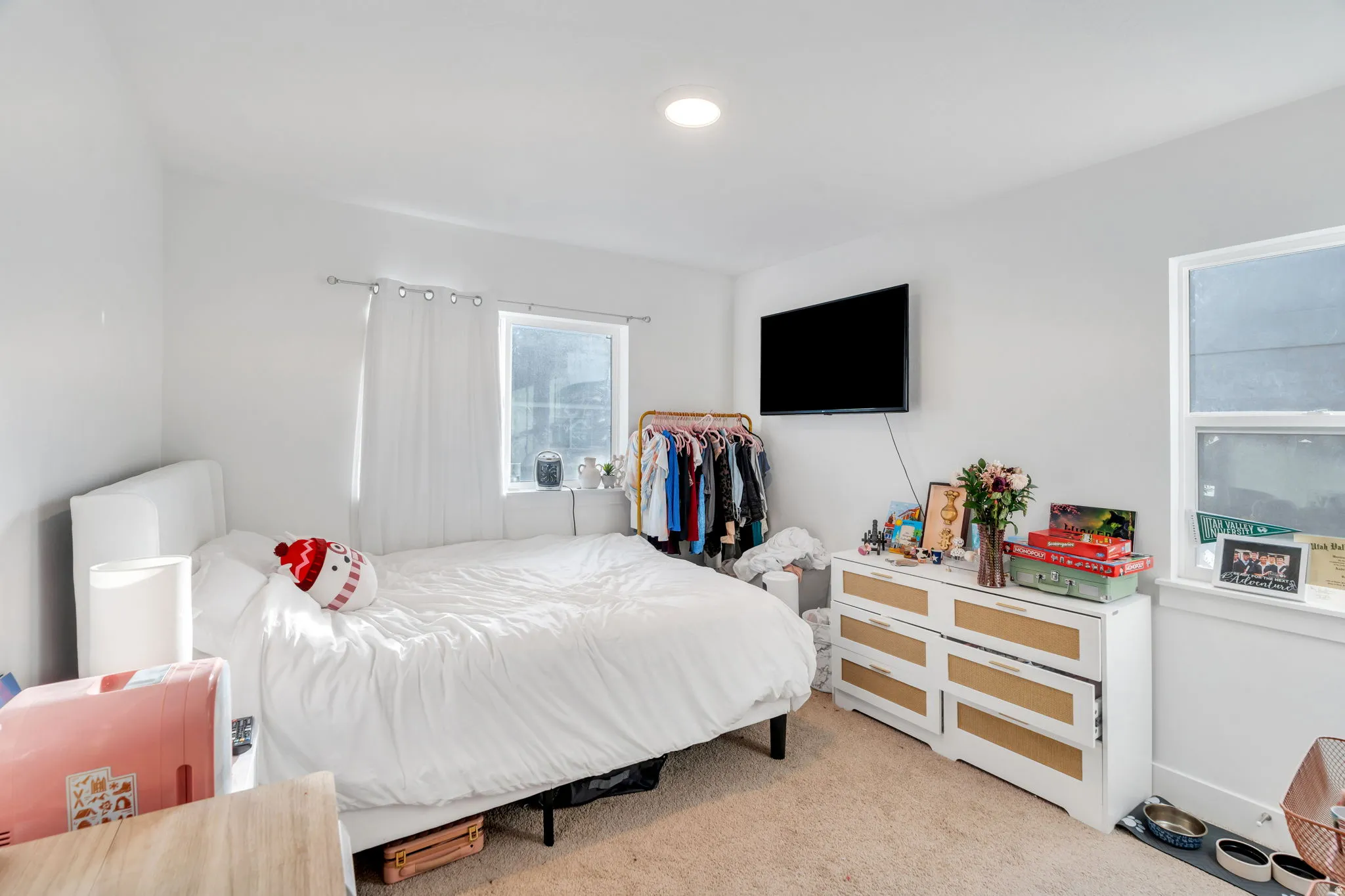 Bedroom featuring light colored carpet