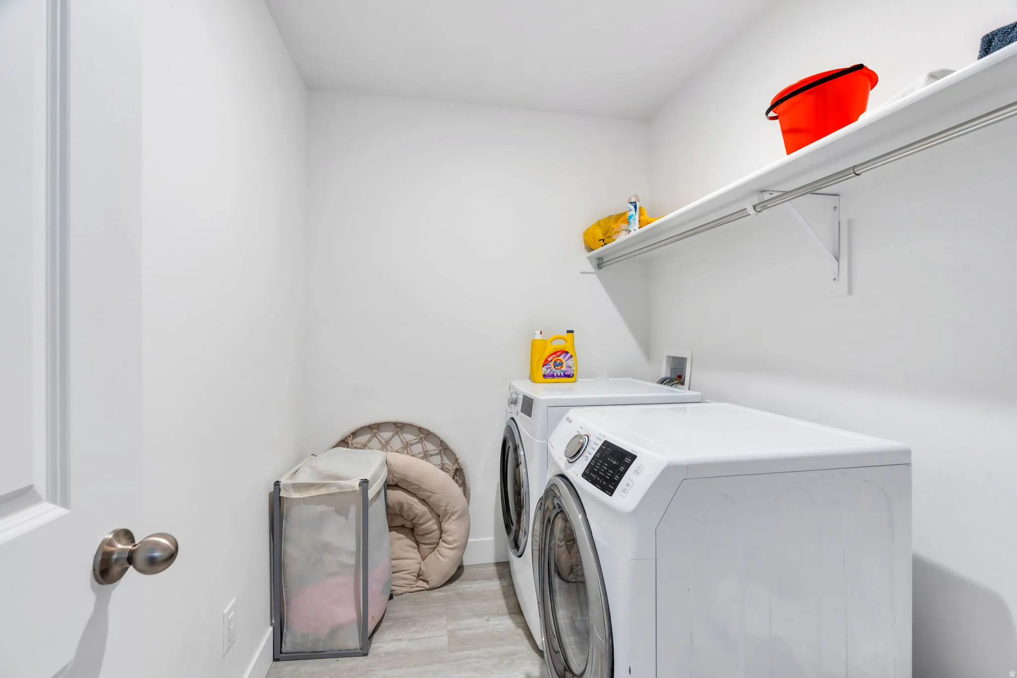 Laundry room featuring light wood finished floors and washing machine and dryer