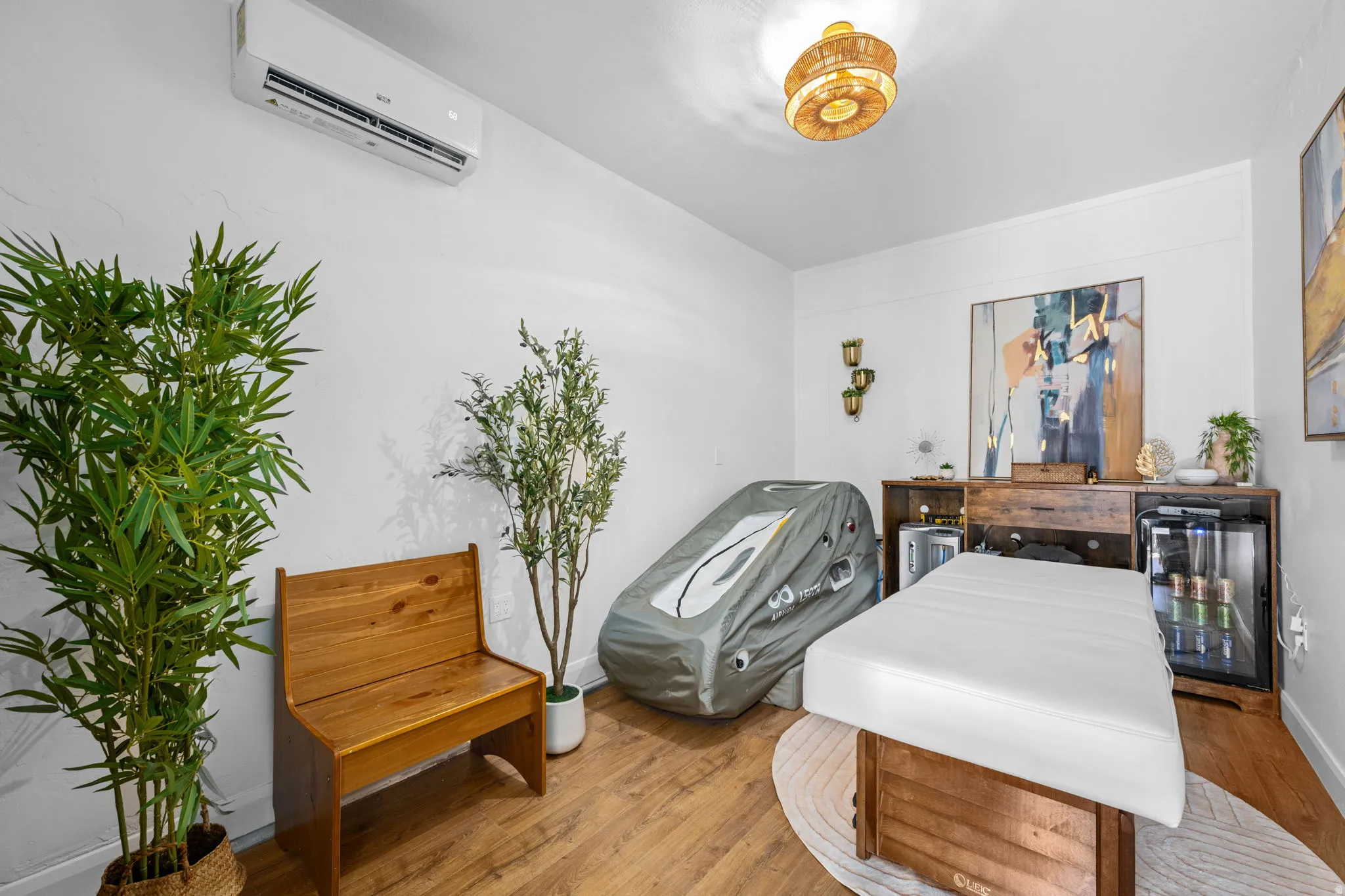 Miscellaneous room with a wall mounted mini split and wood finished floors