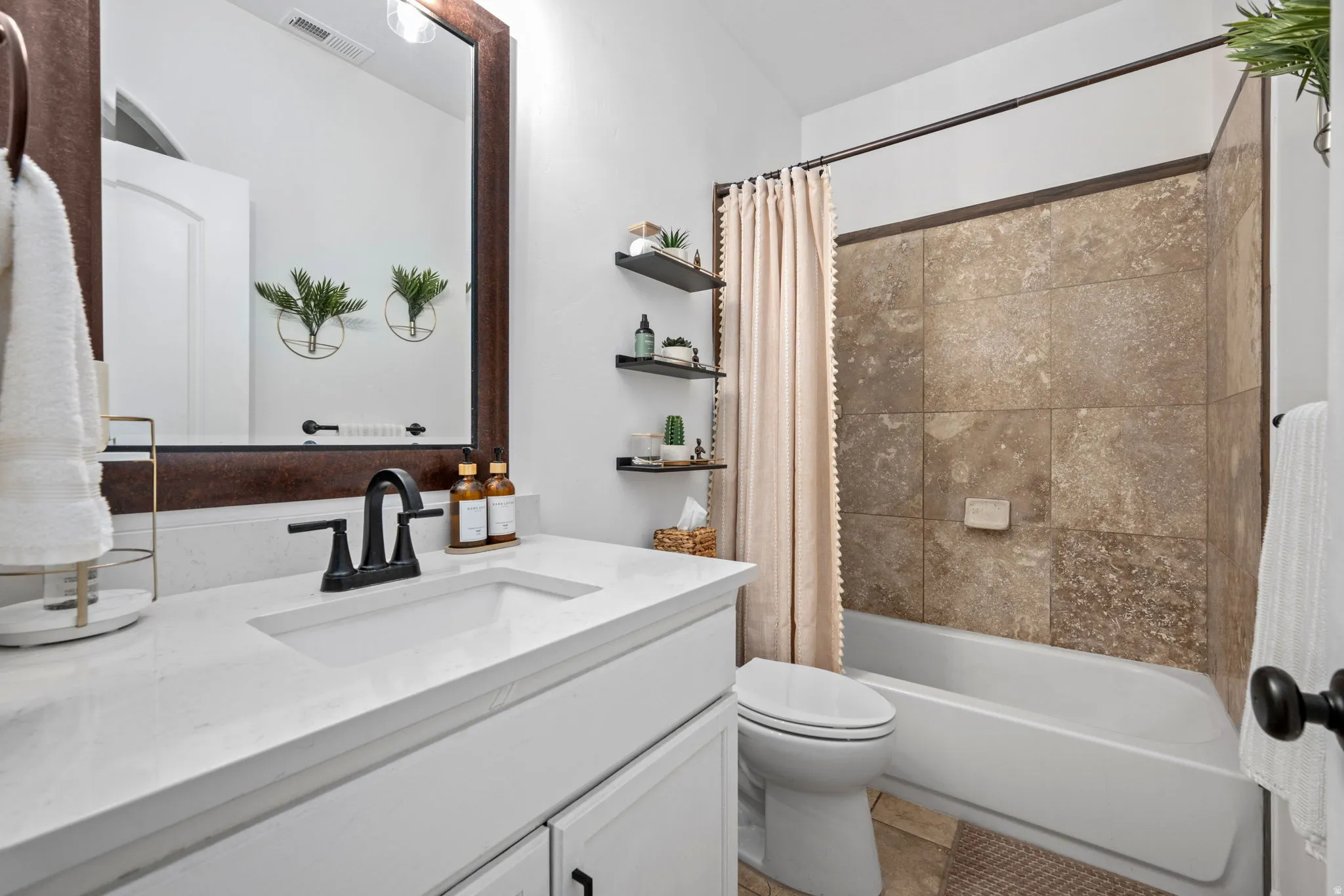 Bathroom featuring vanity and shower / tub combo with curtain