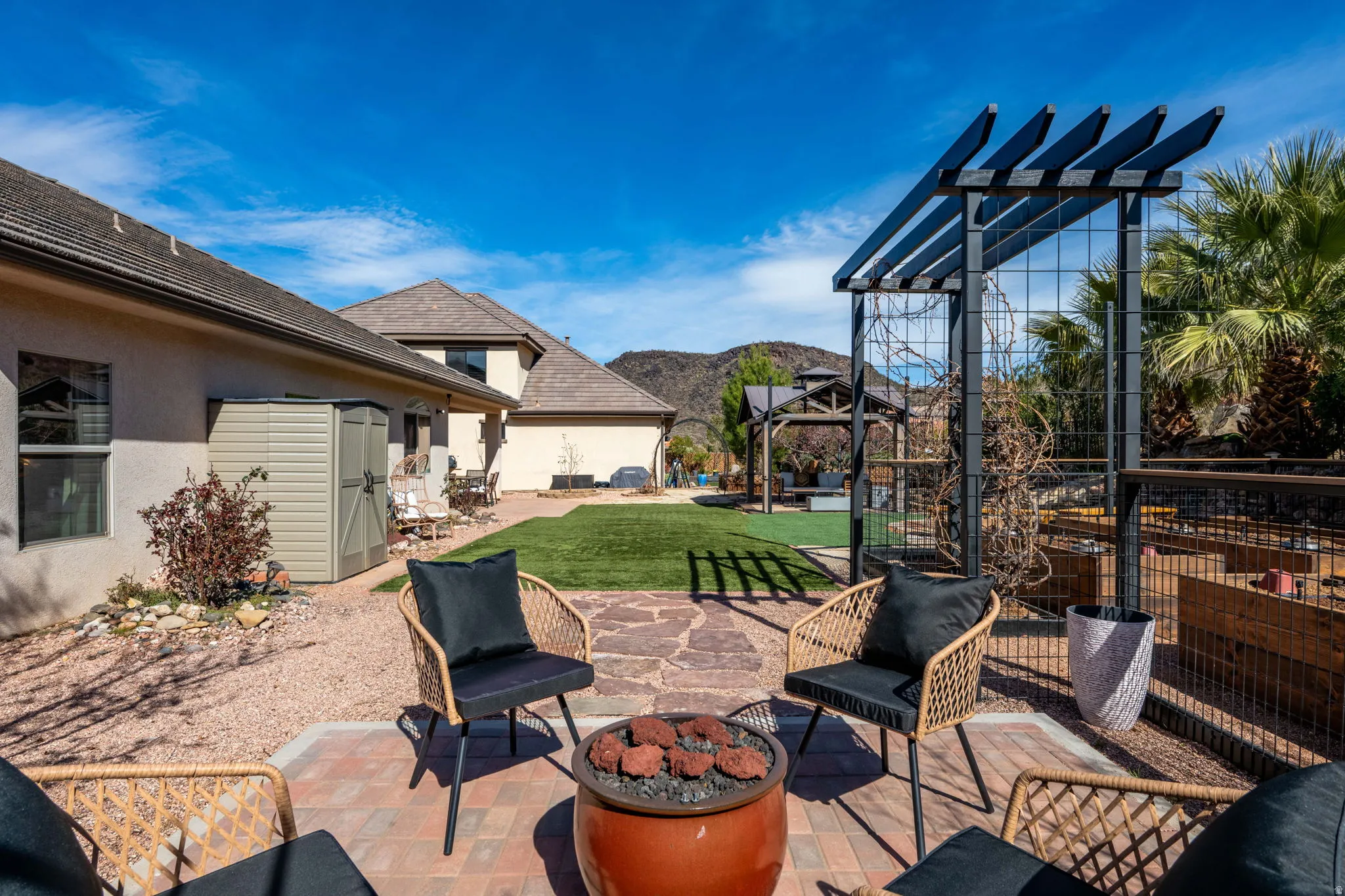 View of patio / terrace featuring a mountain view, a fire pit, and a pergola