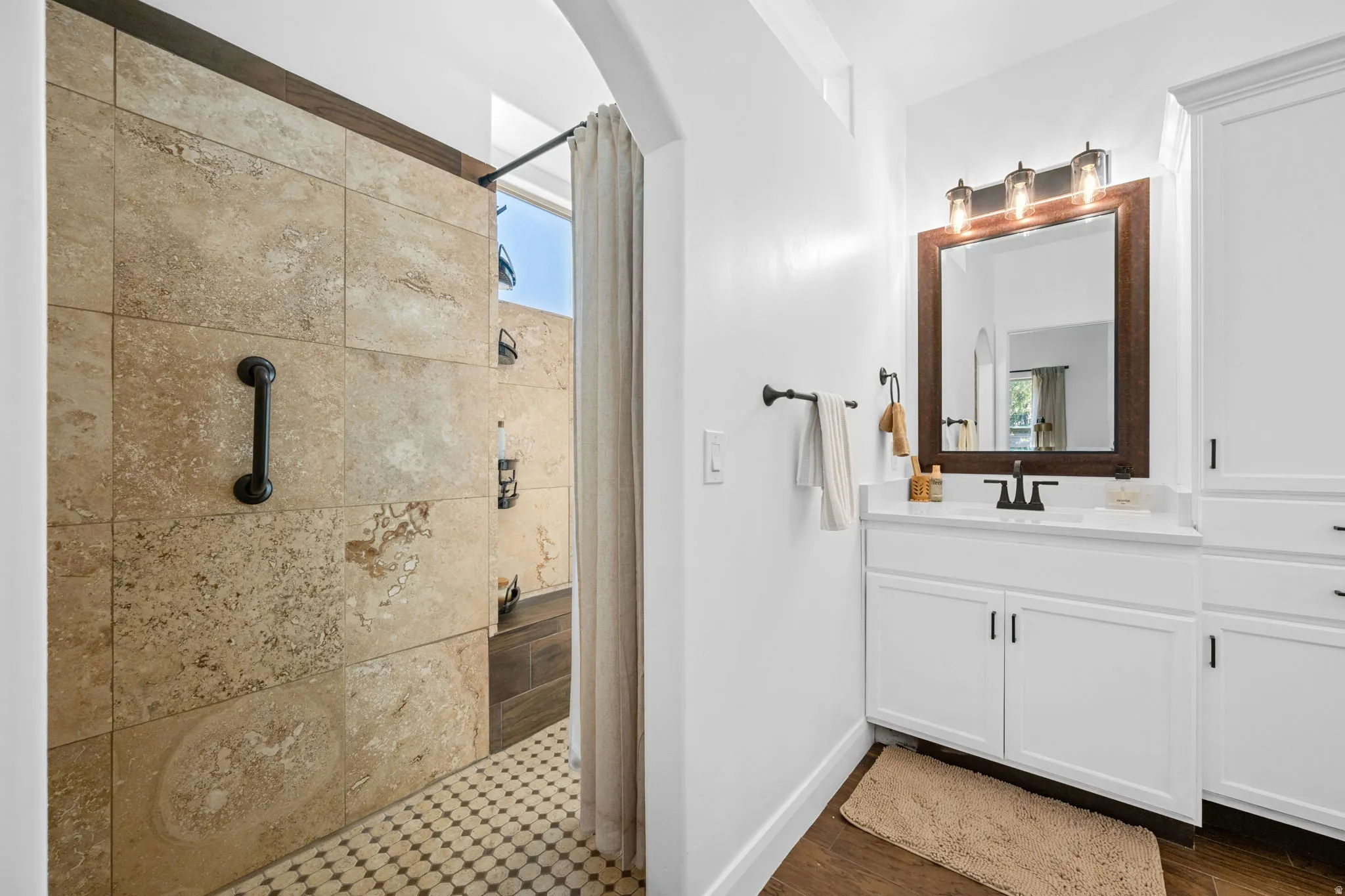 Full bath featuring vanity and a tile shower