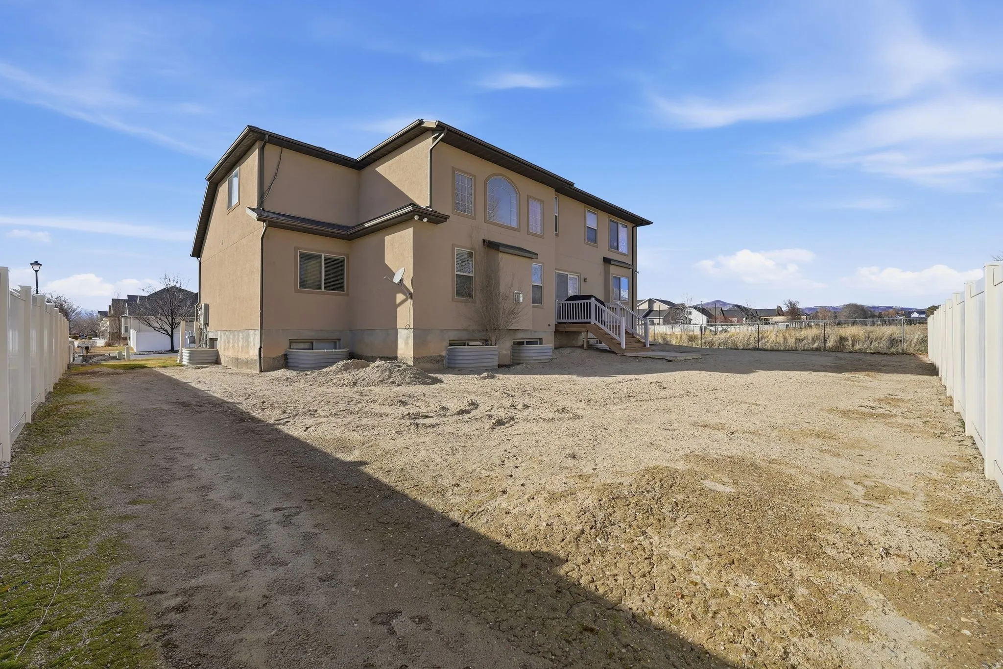 Back of house featuring stucco siding