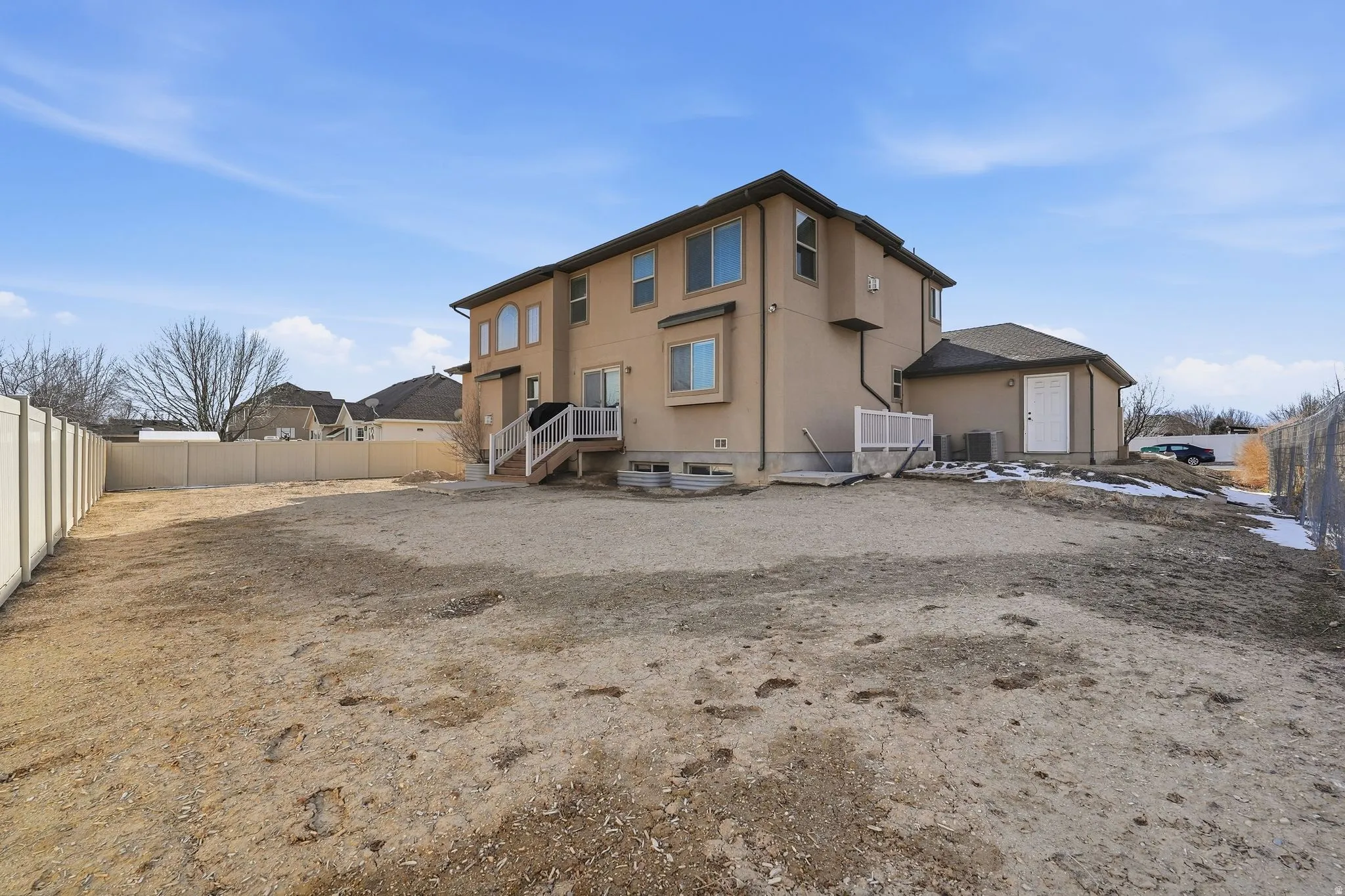 Rear view of house with a fenced backyard