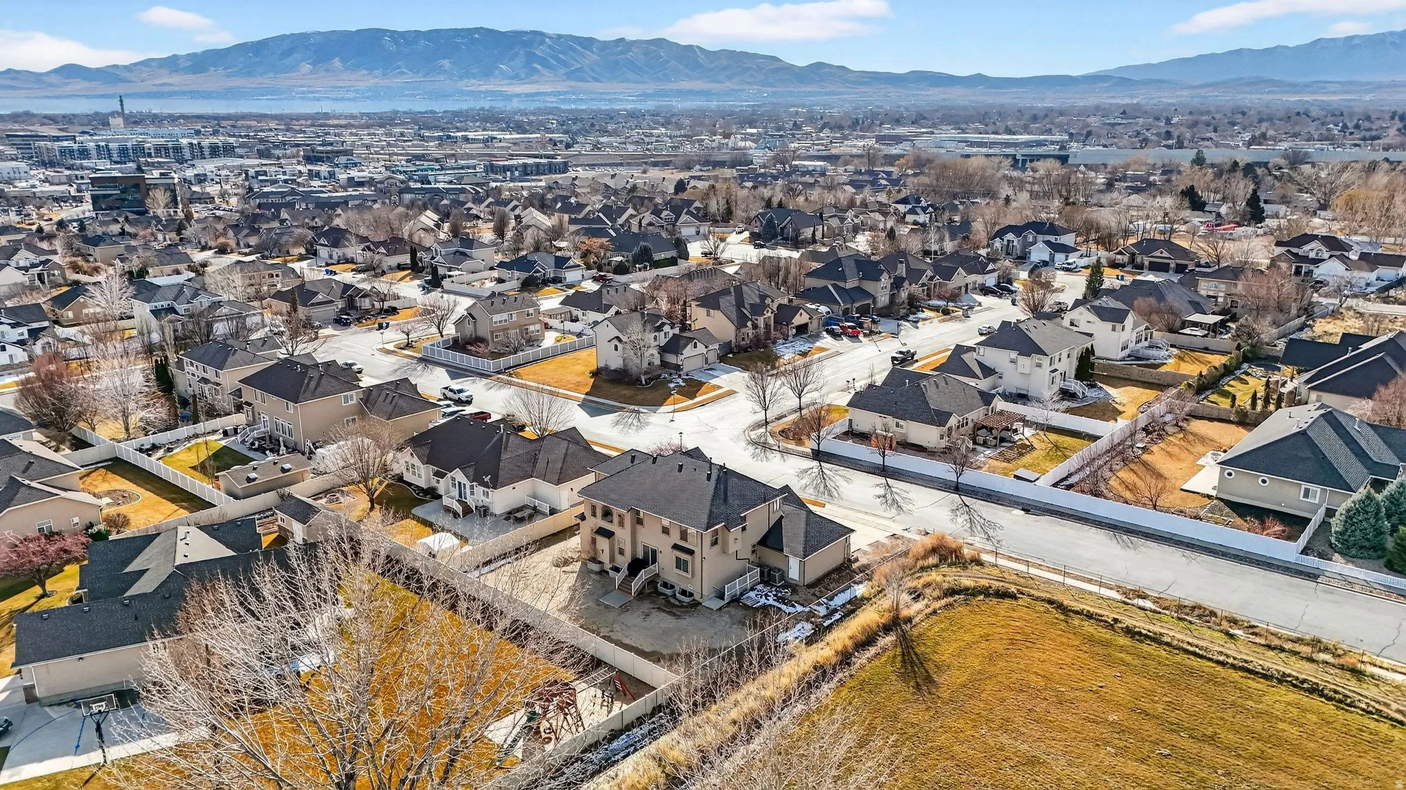 Aerial overview of property's location featuring a mountainous background and nearby suburban area