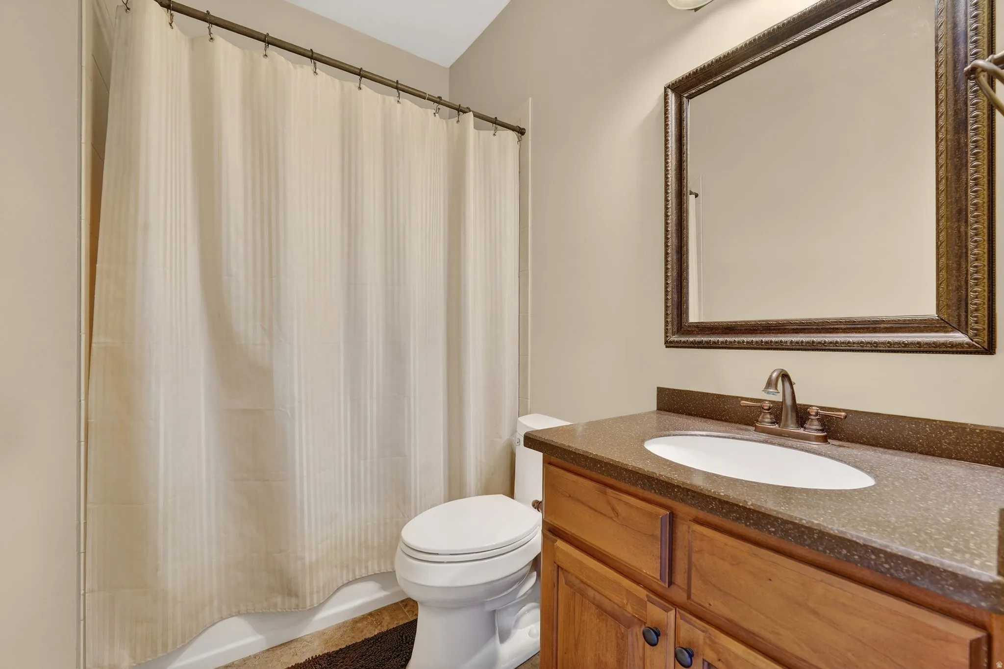 Full bathroom featuring vanity and shower / bath combo with shower curtain