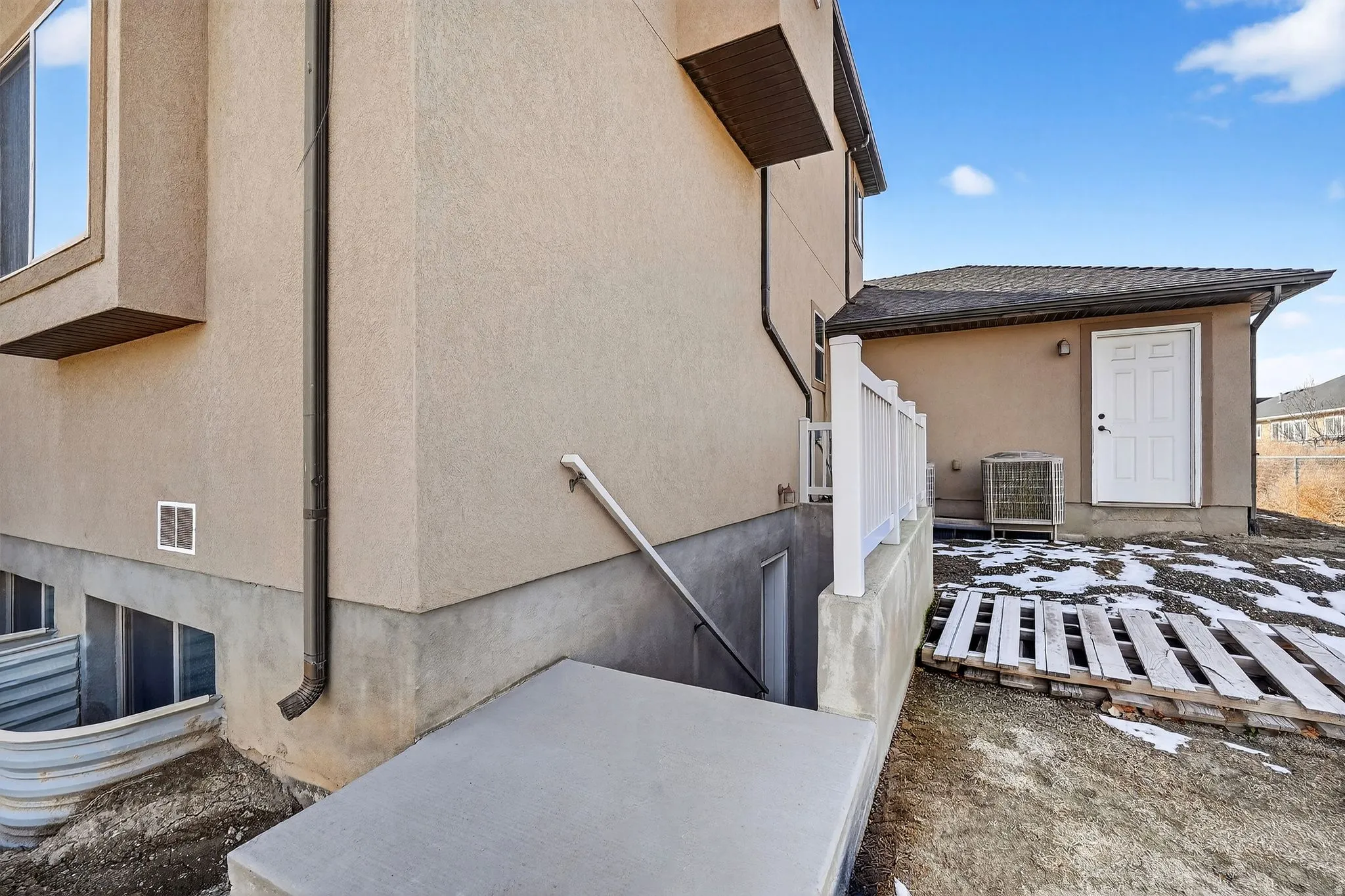 View of side of property with stucco siding and a central air condition unit