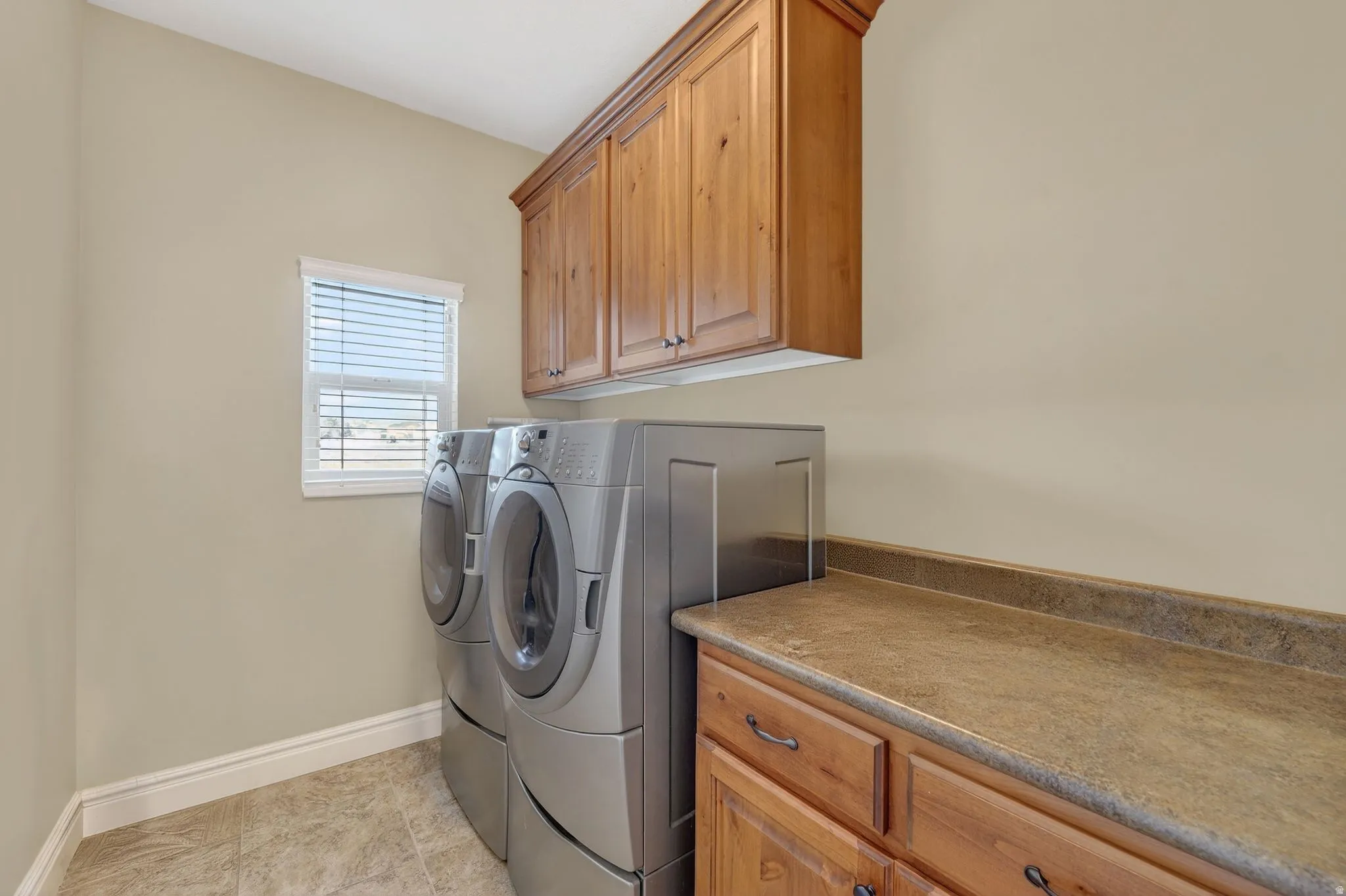 Laundry room with cabinet space and washing machine and dryer