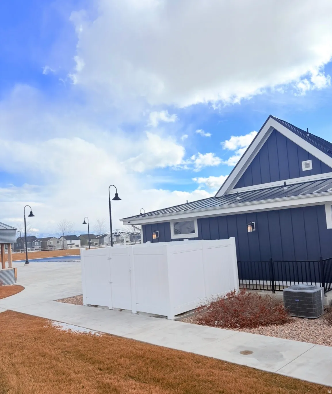 View of property exterior with board and batten siding and a standing seam roof