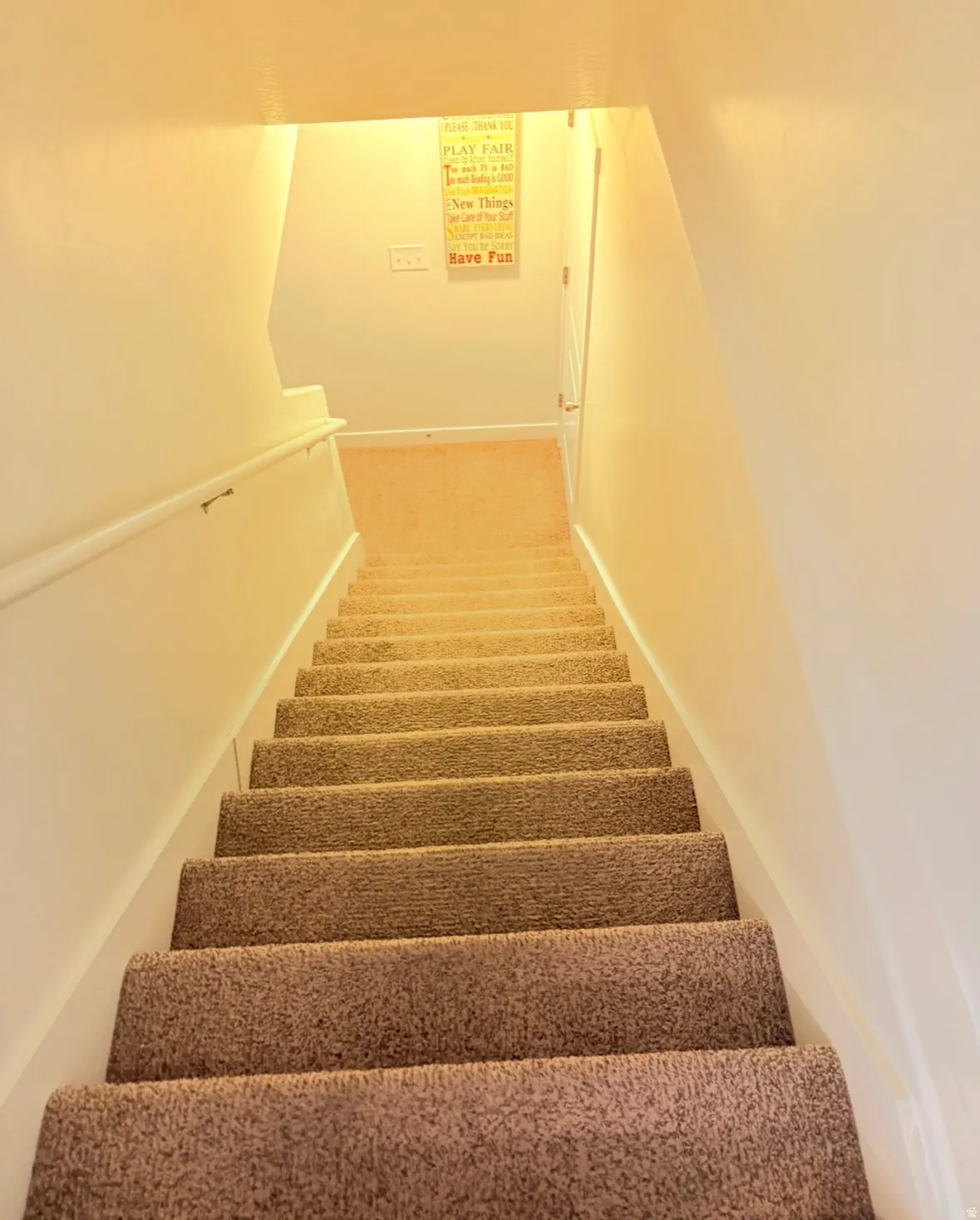 Staircase featuring carpet