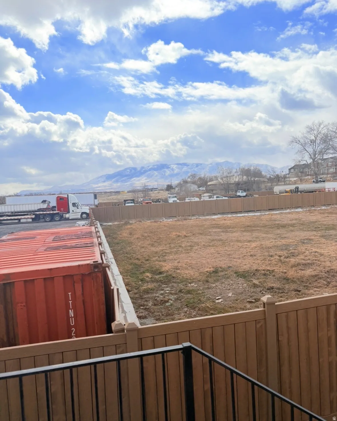 Fenced yard with a mountain view and a balcony