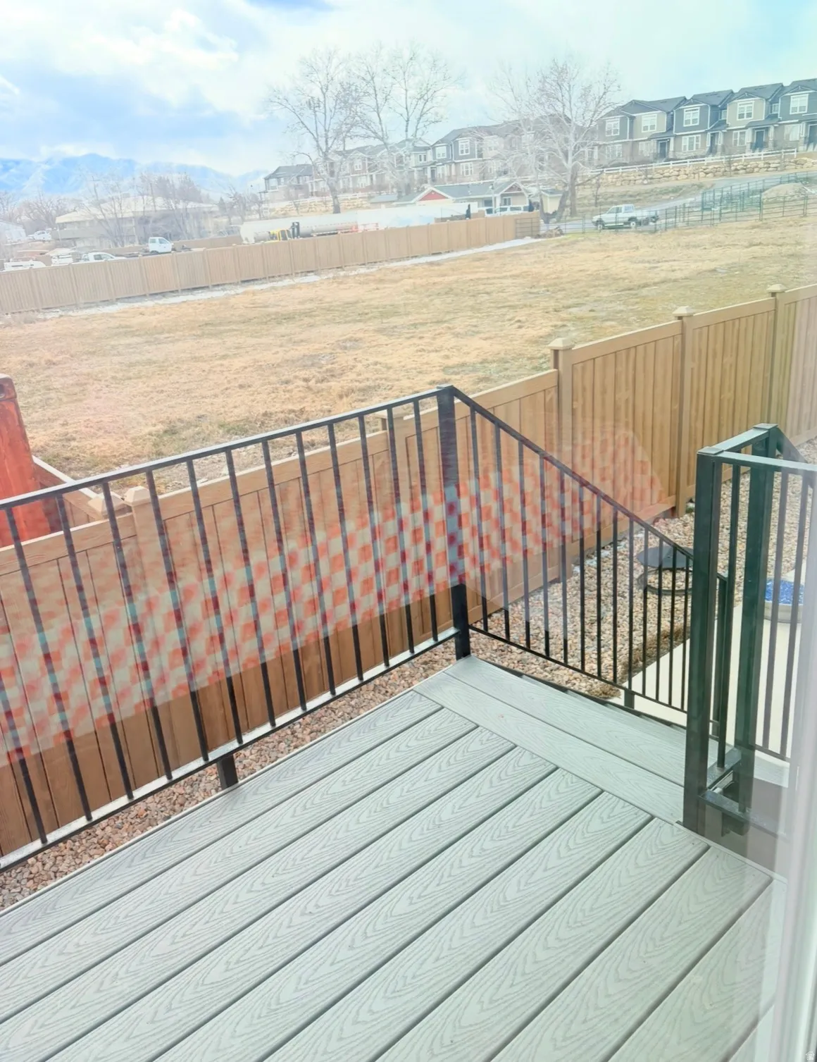 Wooden deck with a fenced backyard and a residential view