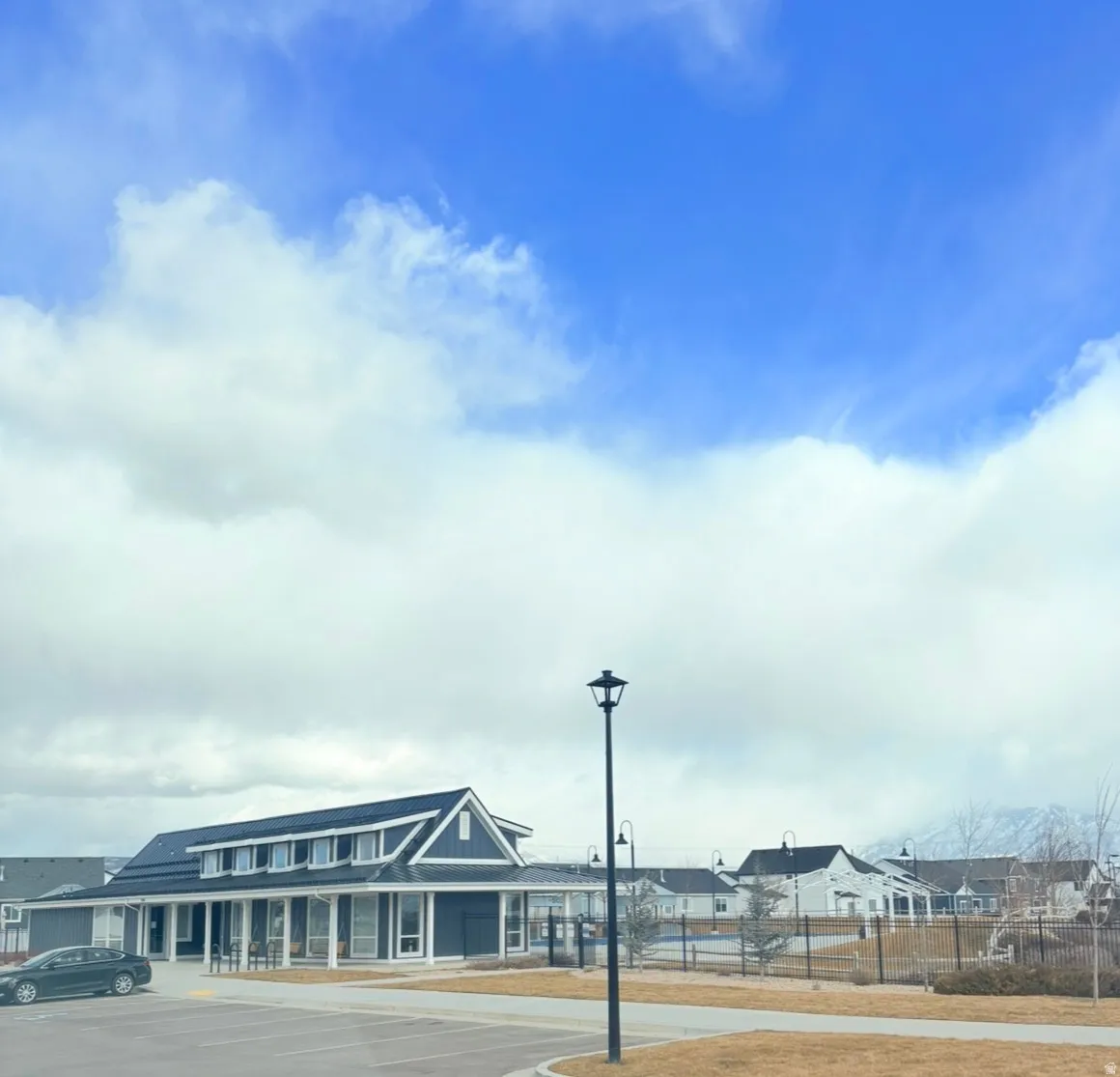 View of asphalt street featuring street lighting and a residential view