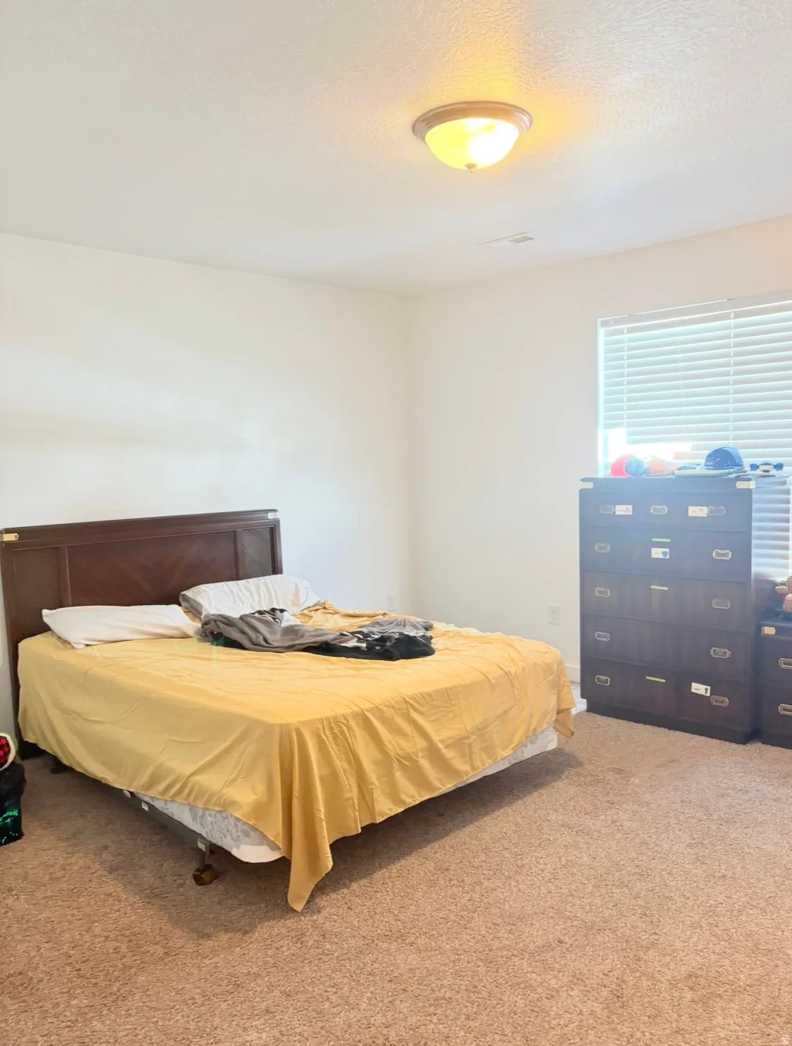 Carpeted bedroom featuring a textured ceiling