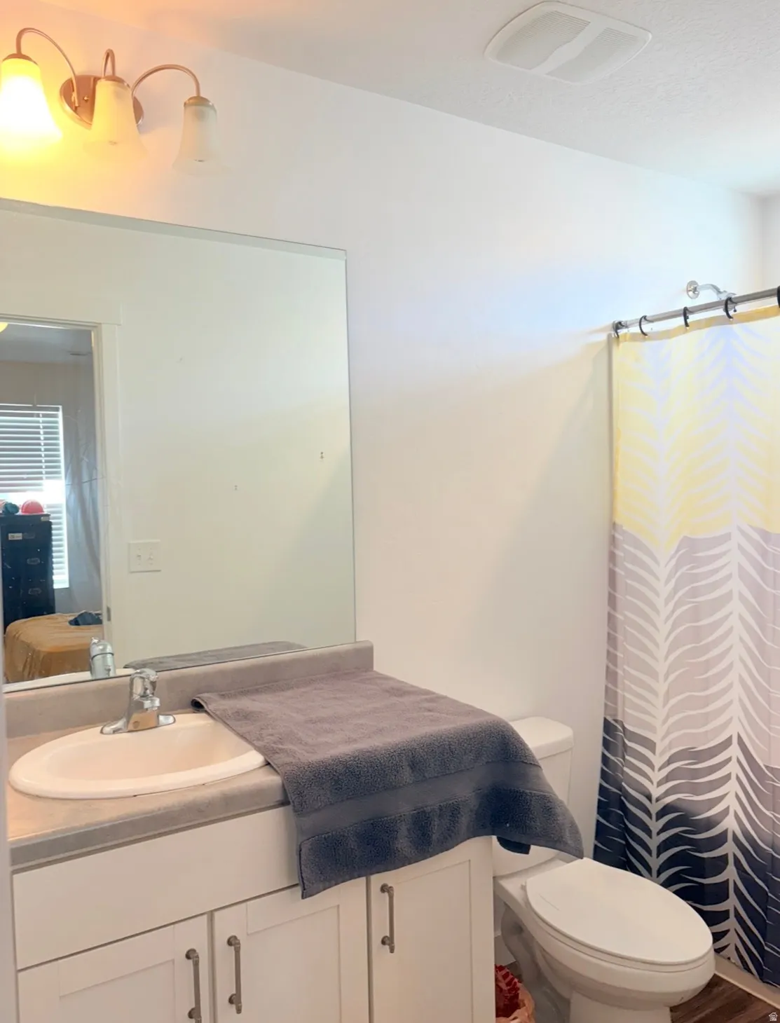 Full bathroom featuring vanity, curtained shower, and ensuite bath