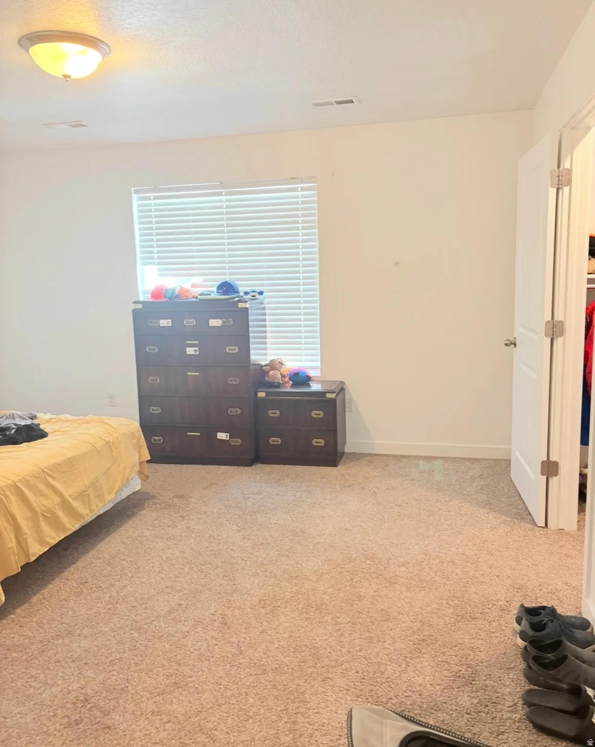 Bedroom featuring light colored carpet and baseboards