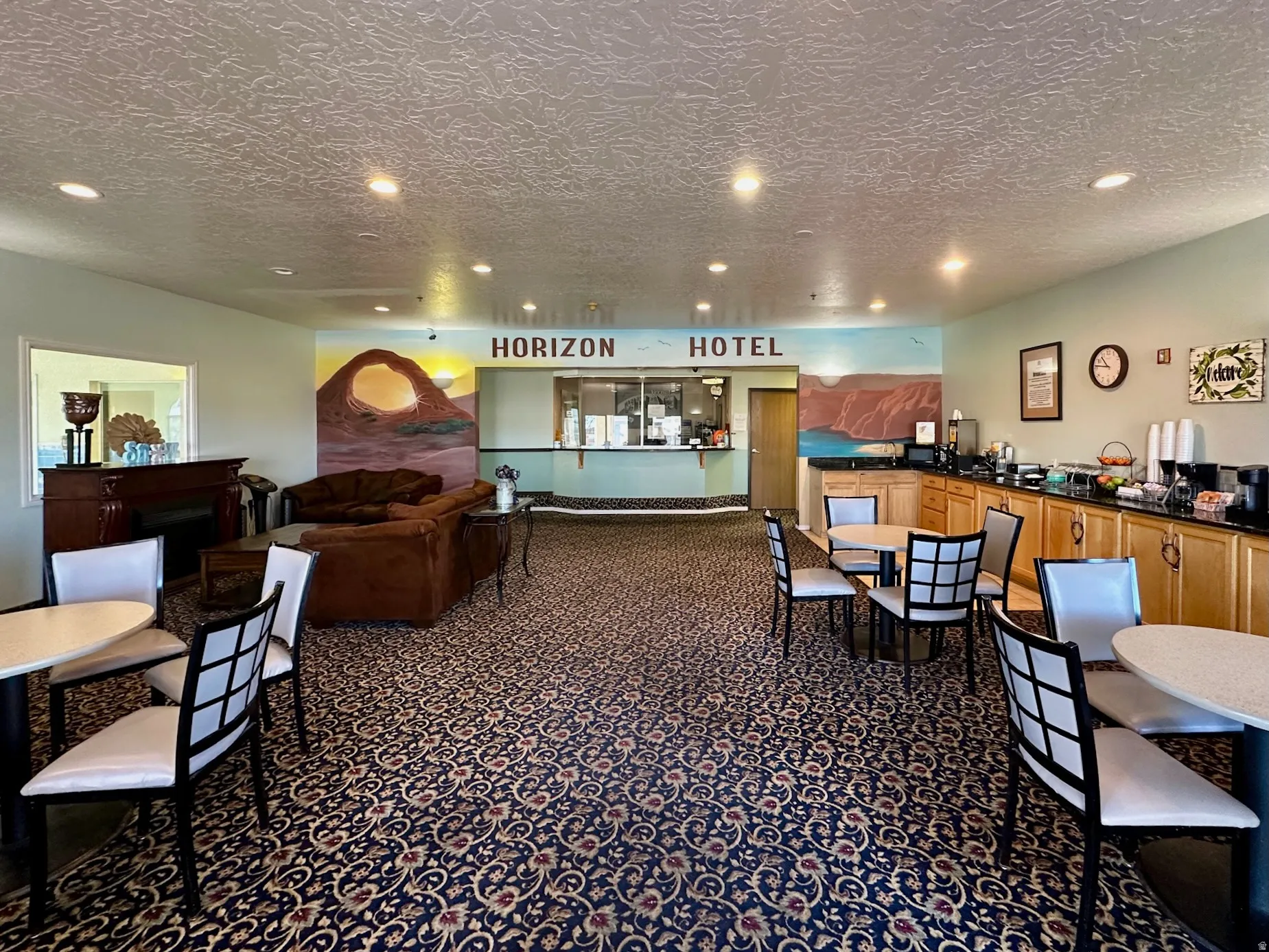 Dining area featuring a textured ceiling, recessed lighting, and dark carpet