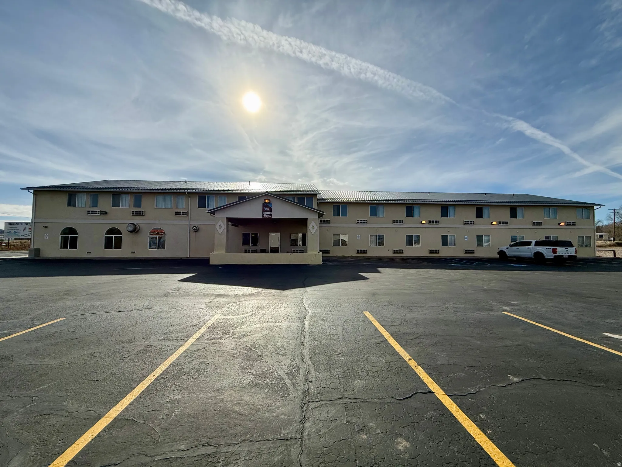 View of property featuring uncovered parking