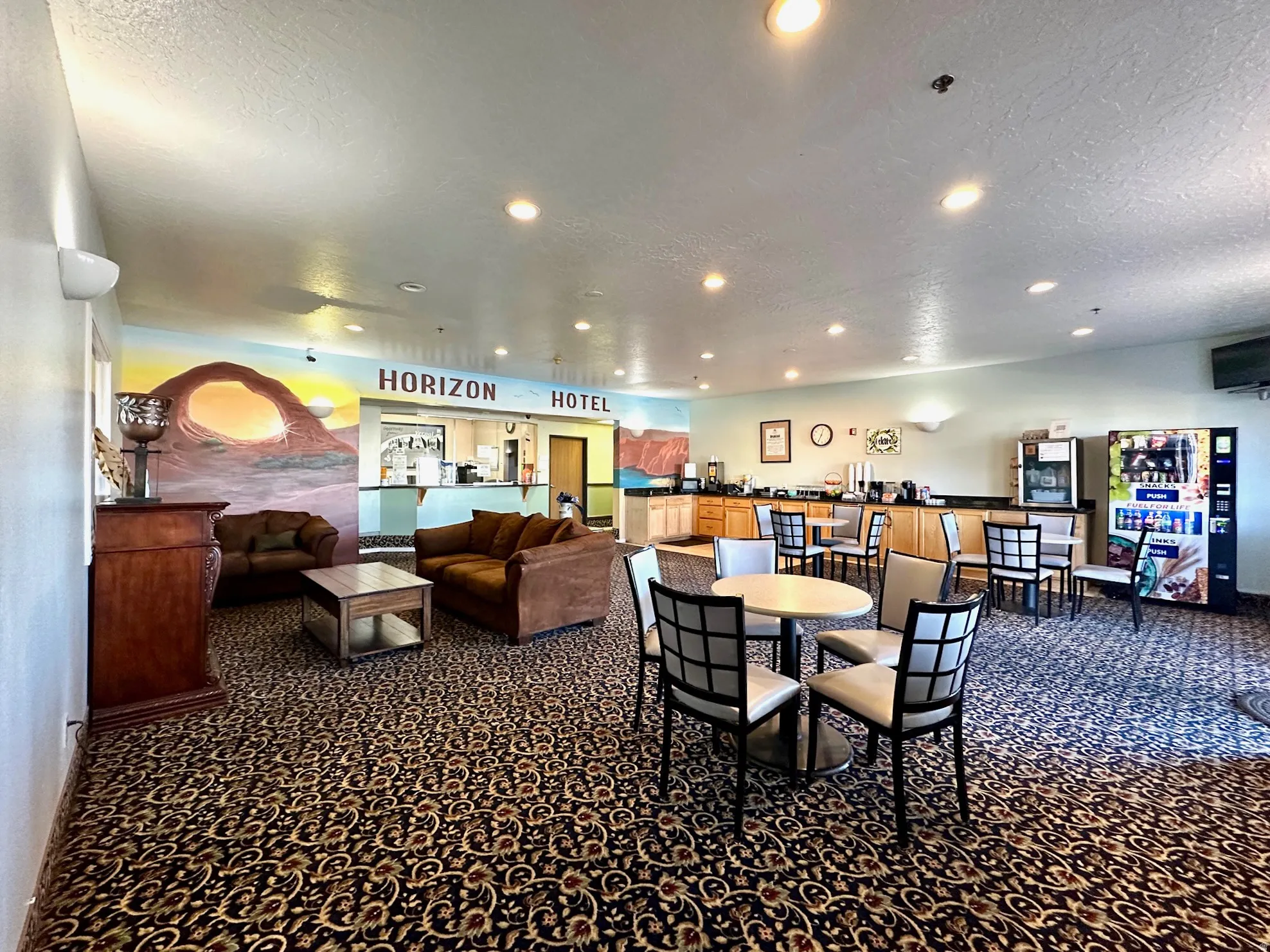 Dining space with dark carpet, a textured ceiling, and recessed lighting