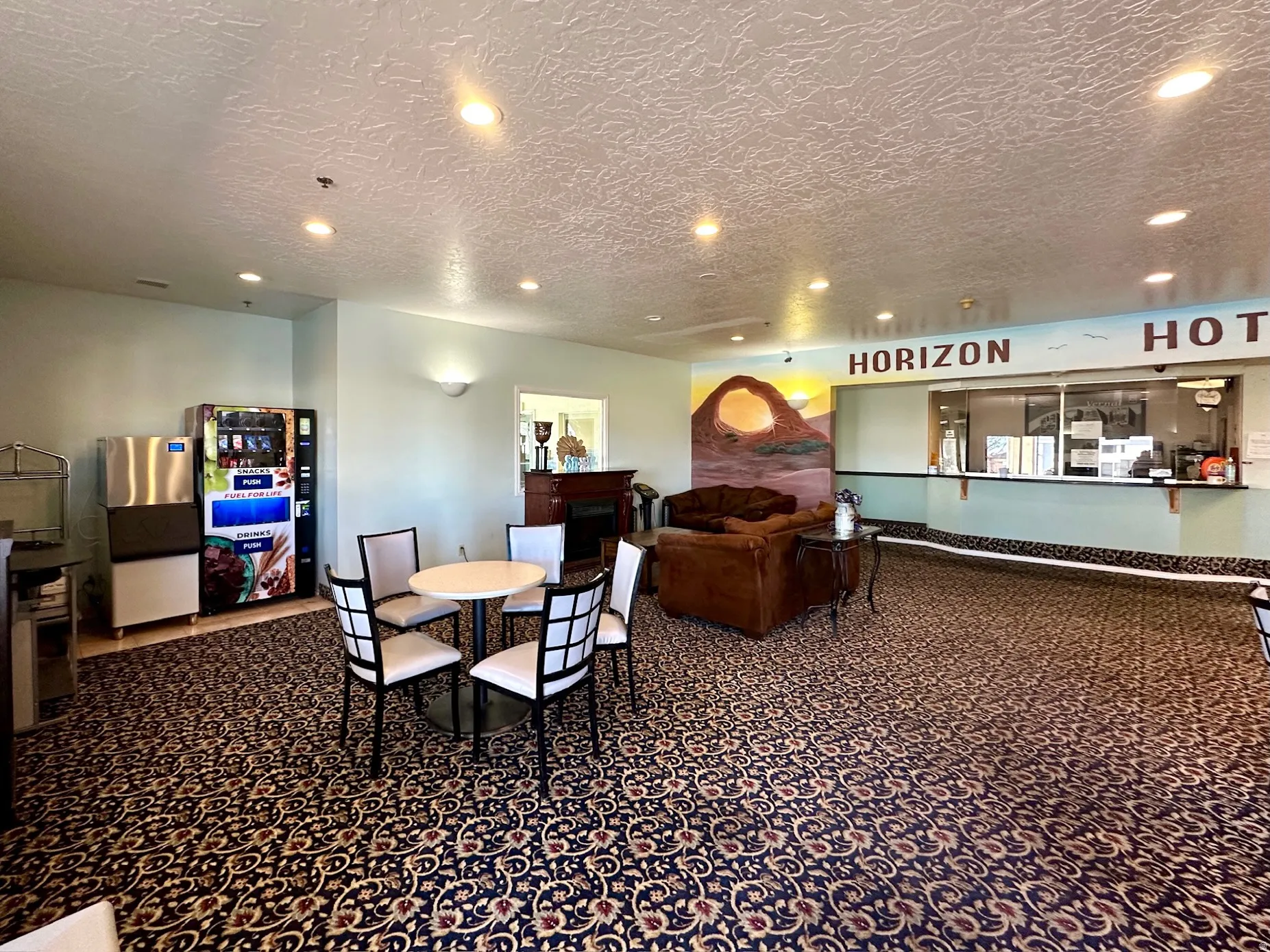 Dining room featuring dark carpet, recessed lighting, and a textured ceiling