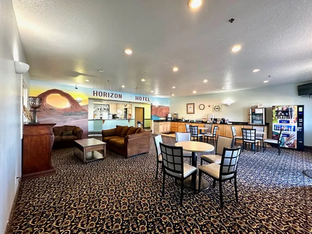 Dining space with dark carpet, a textured ceiling, and recessed lighting