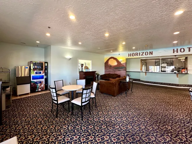 Dining room featuring dark carpet, recessed lighting, and a textured ceiling