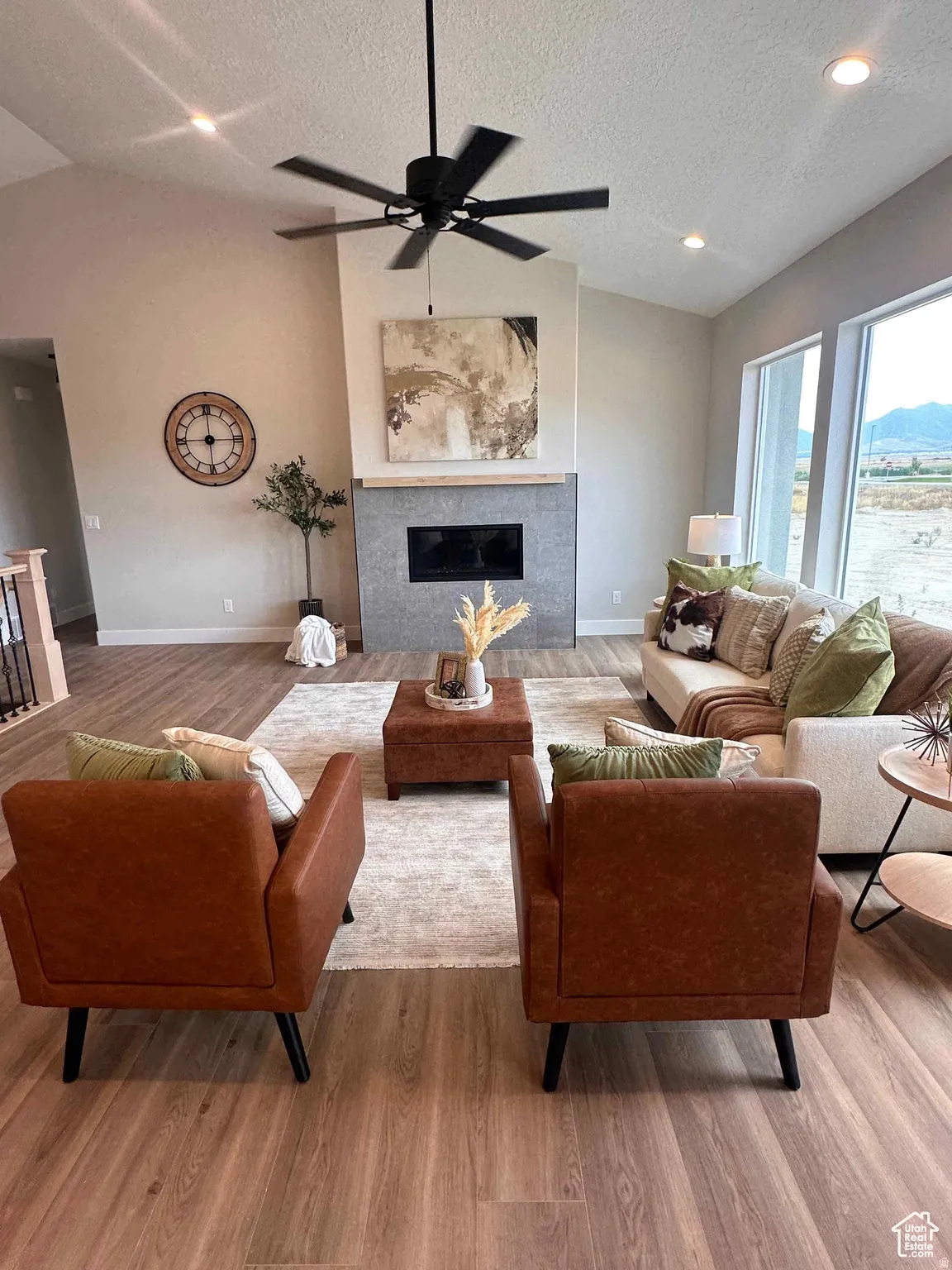 Living area featuring a tile fireplace, light wood-style floors, ceiling fan, and recessed lighting