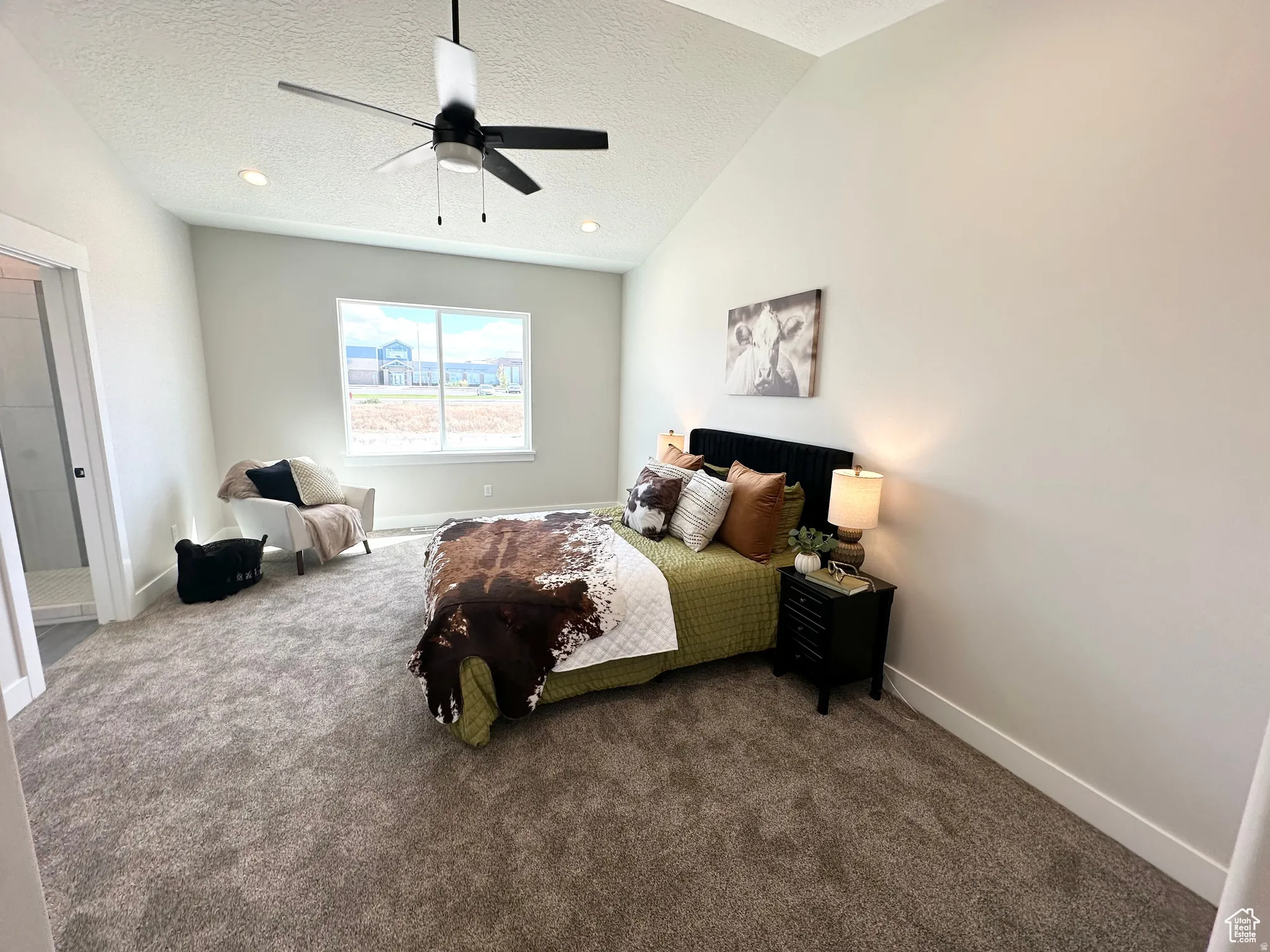 Carpeted bedroom with baseboards and a ceiling fan