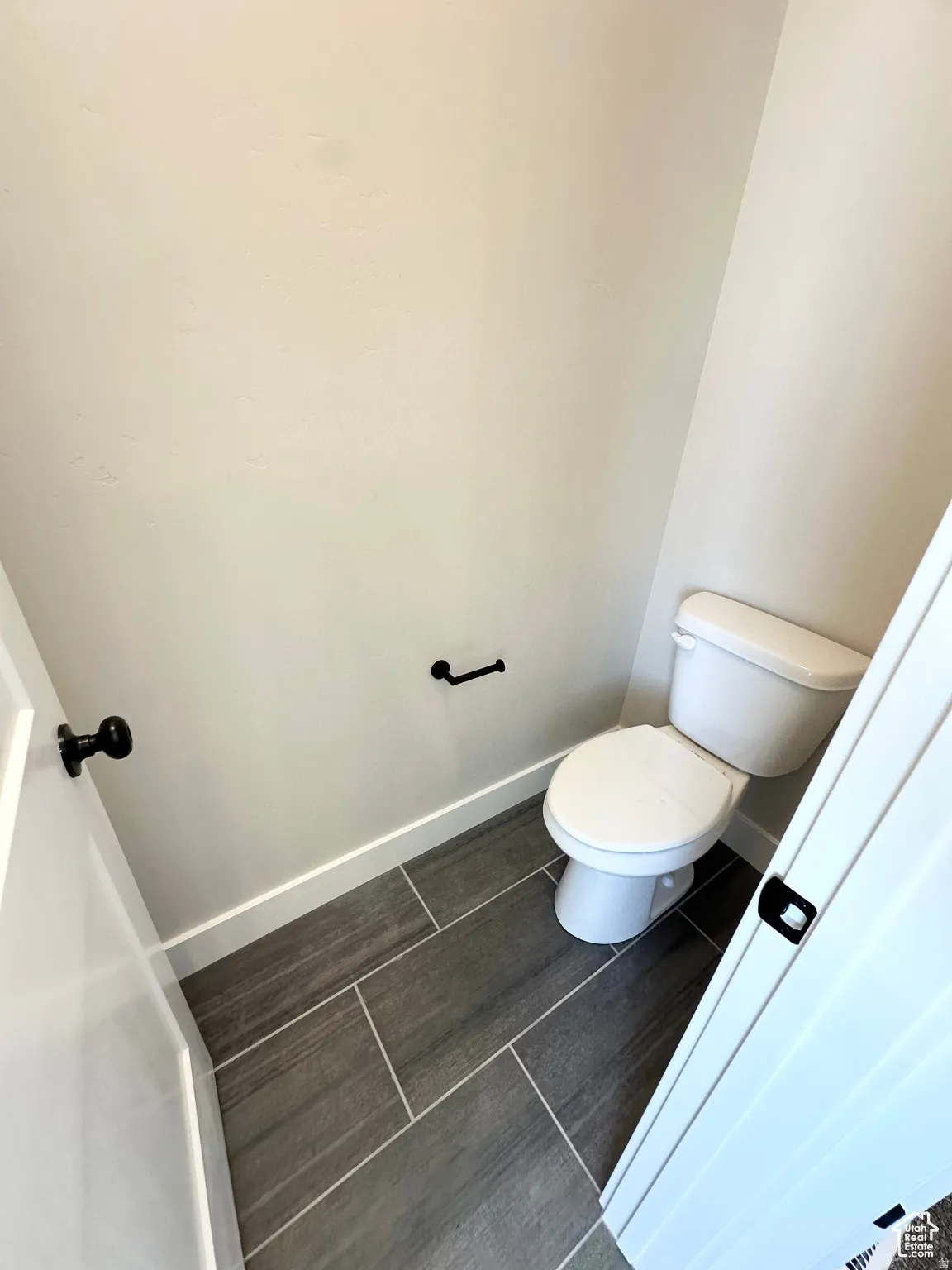 Bathroom featuring baseboards and toilet