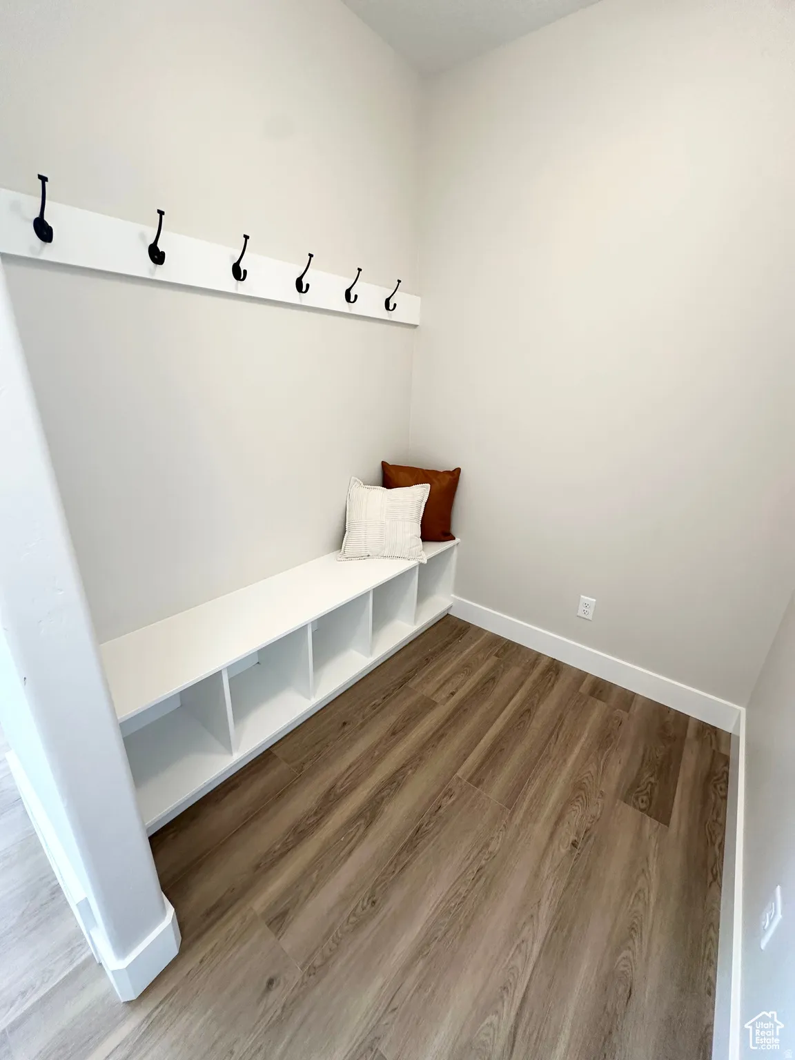 Mudroom with wood finished floors and baseboards