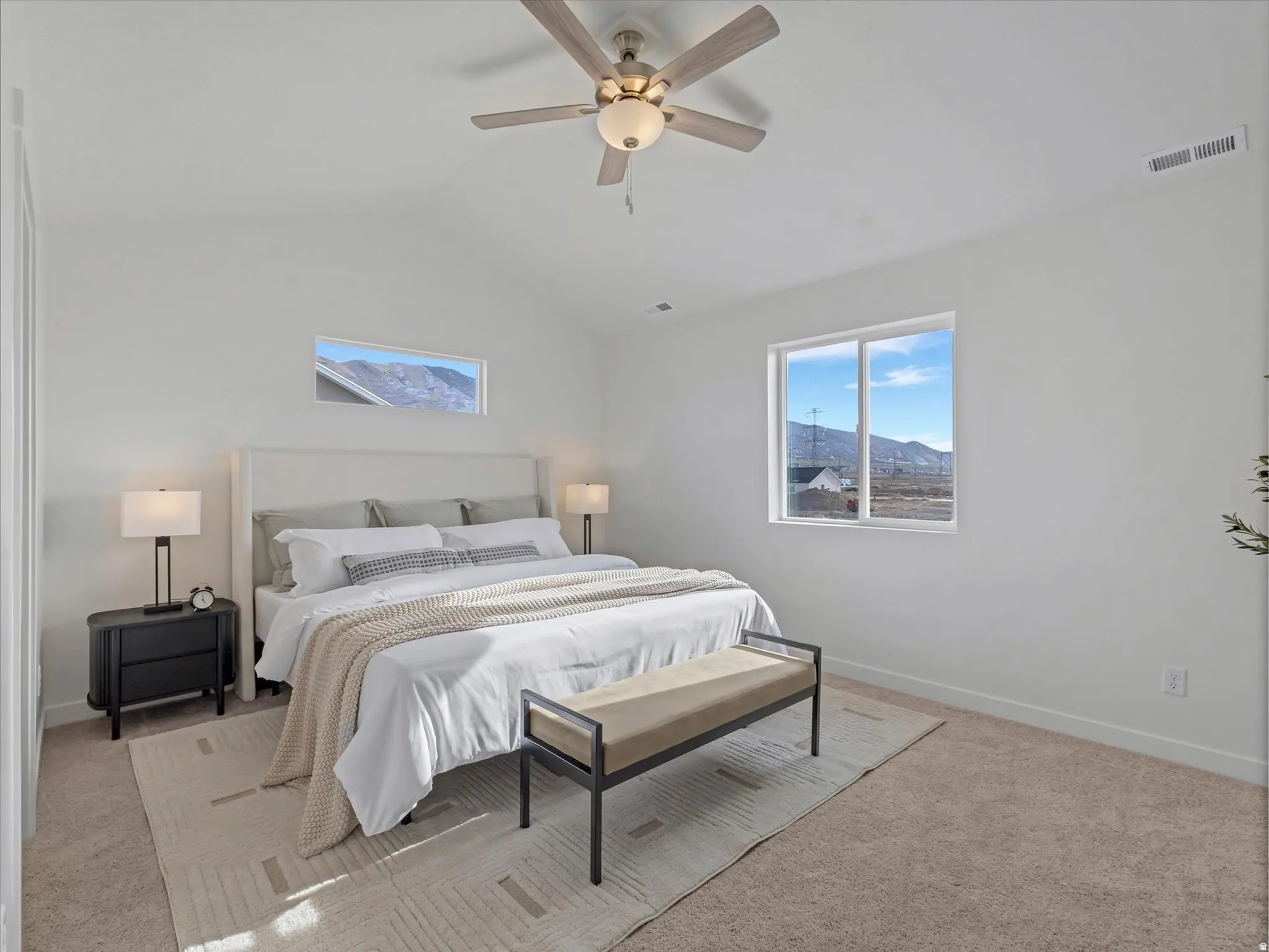 Bedroom with light colored carpet, a mountain view, a ceiling fan, and lofted ceiling