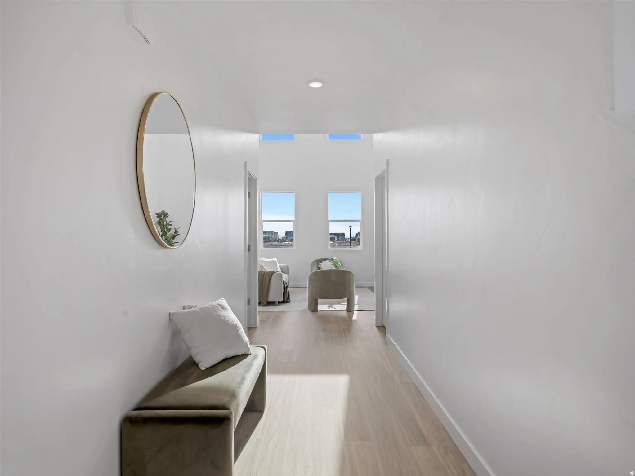 Corridor featuring light wood-type flooring and recessed lighting