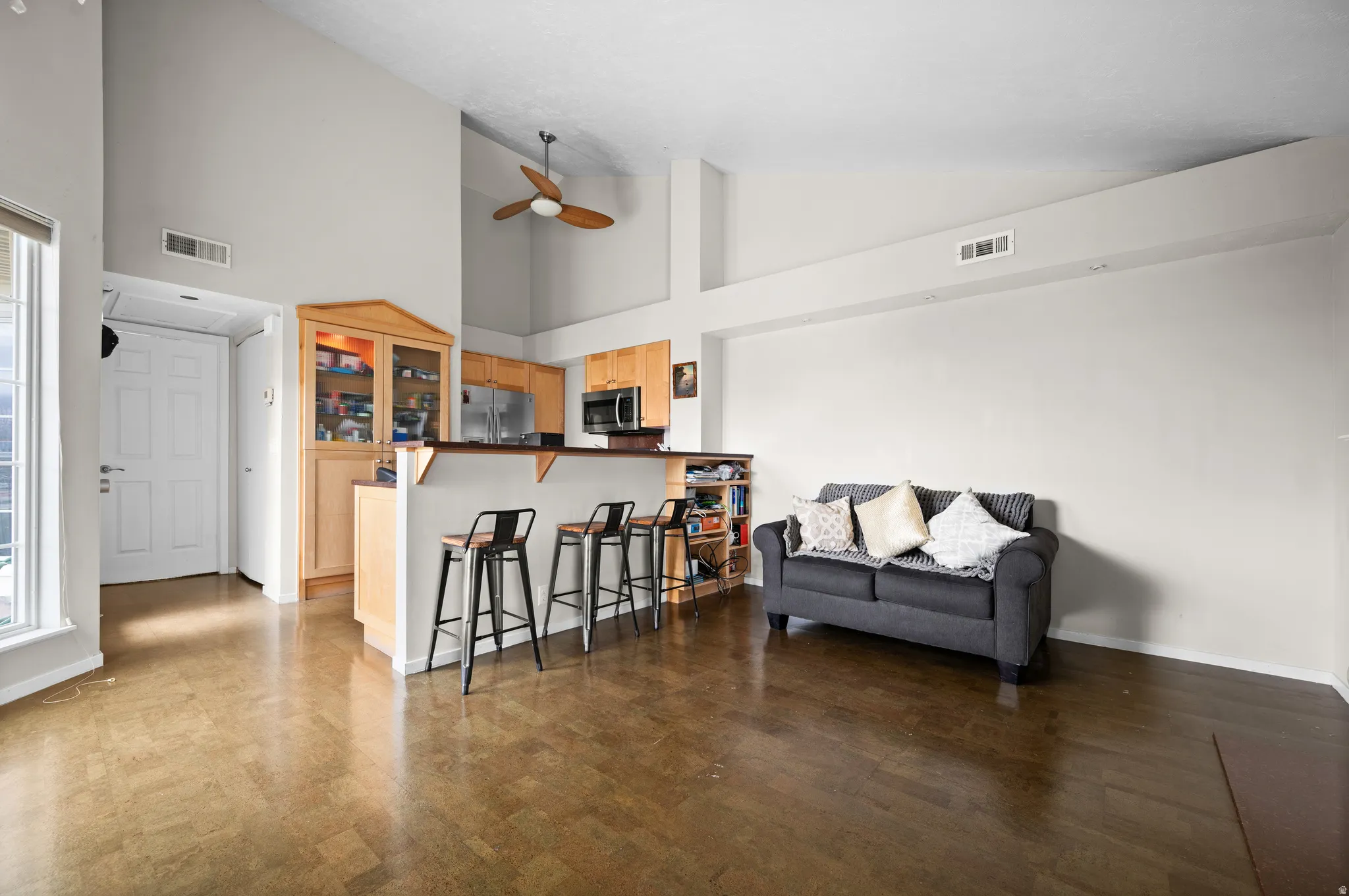 Living room featuring vaulted ceiling and a ceiling fan