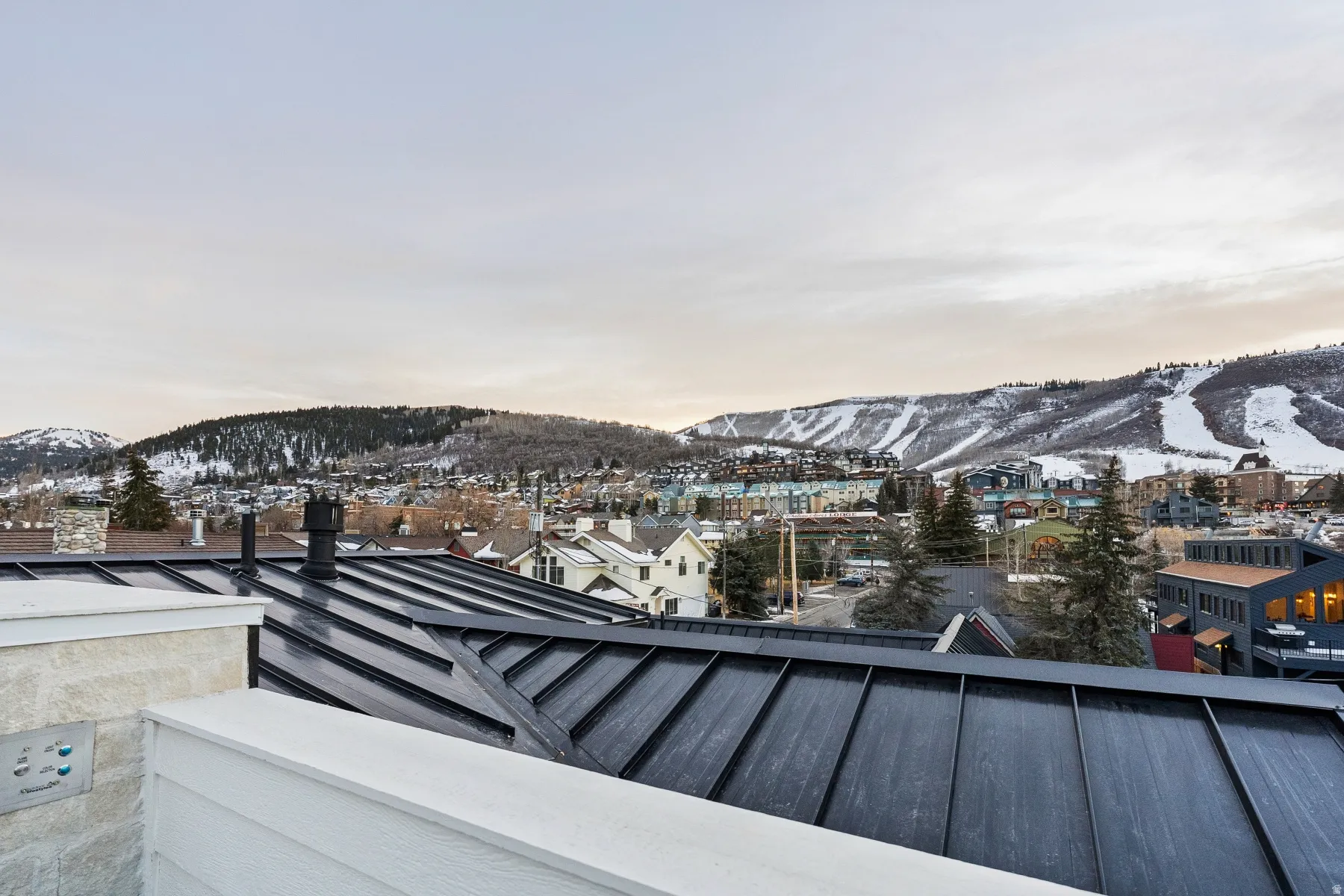 Snow covered back of property featuring a mountain view