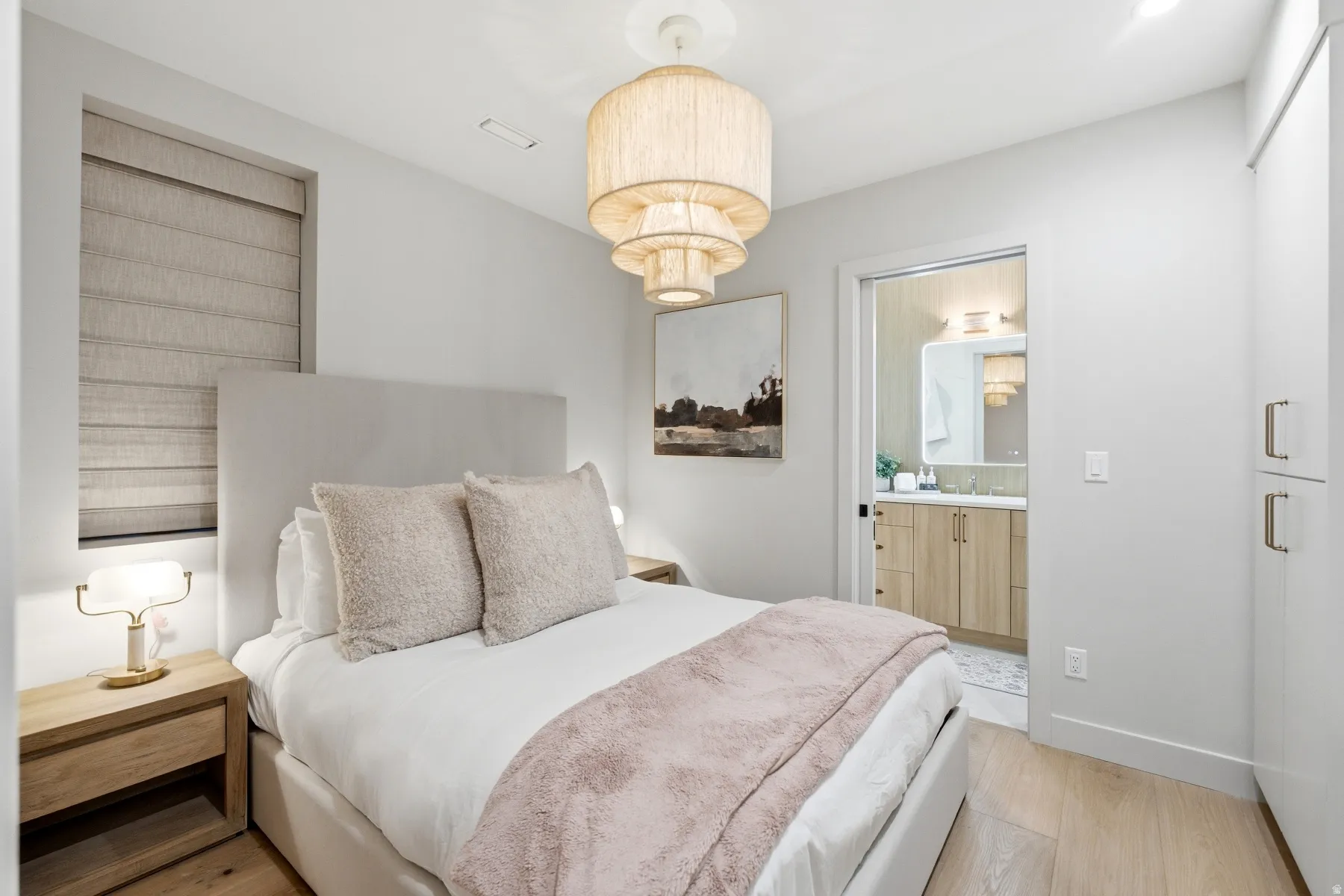 Bedroom with light wood-style flooring and baseboards