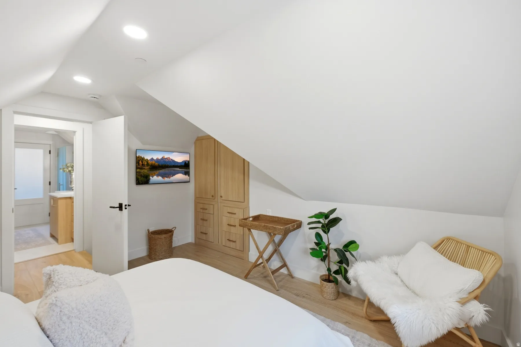 Bedroom with lofted ceiling, light wood finished floors, and recessed lighting