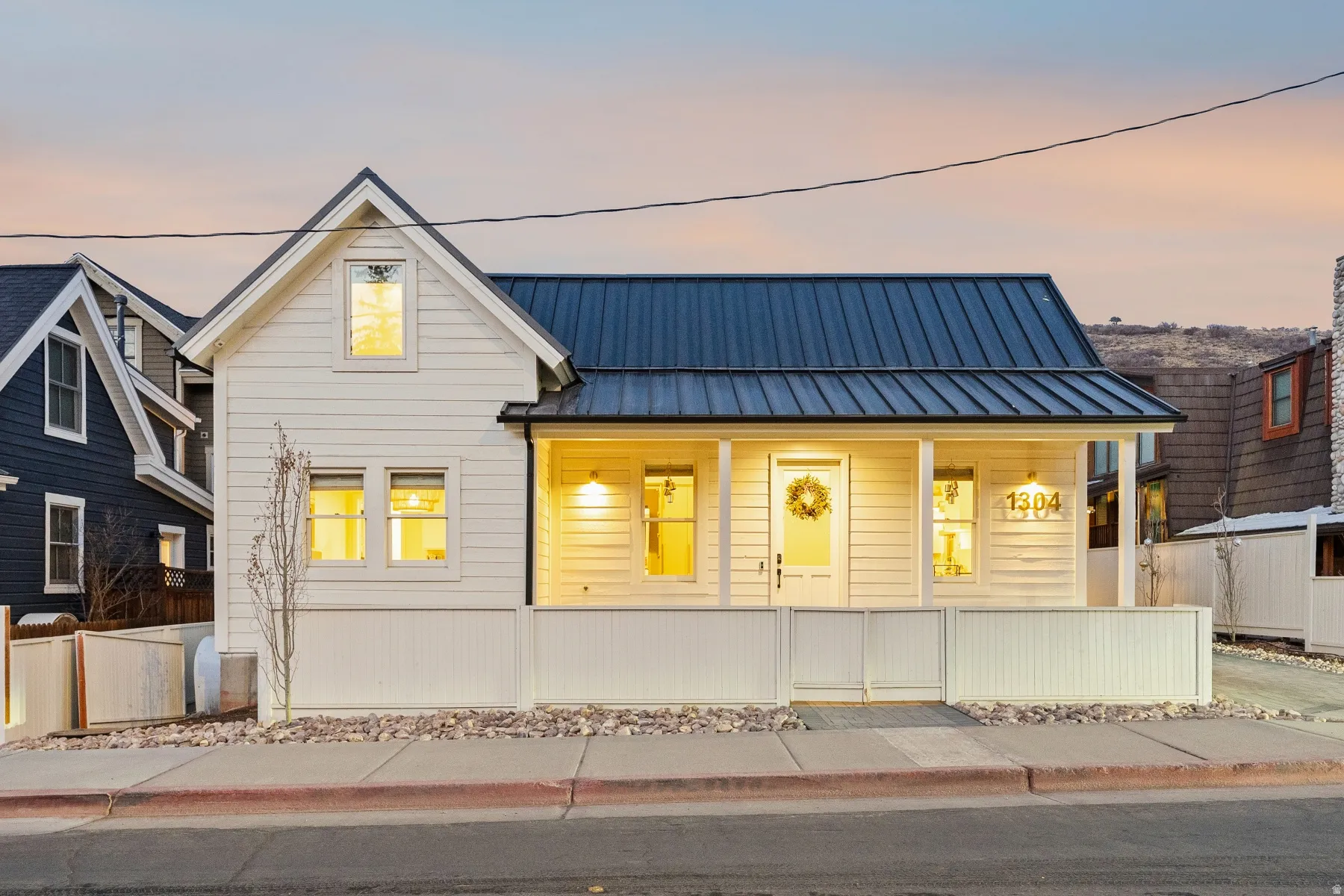 View of front of house with a porch and a standing seam roof