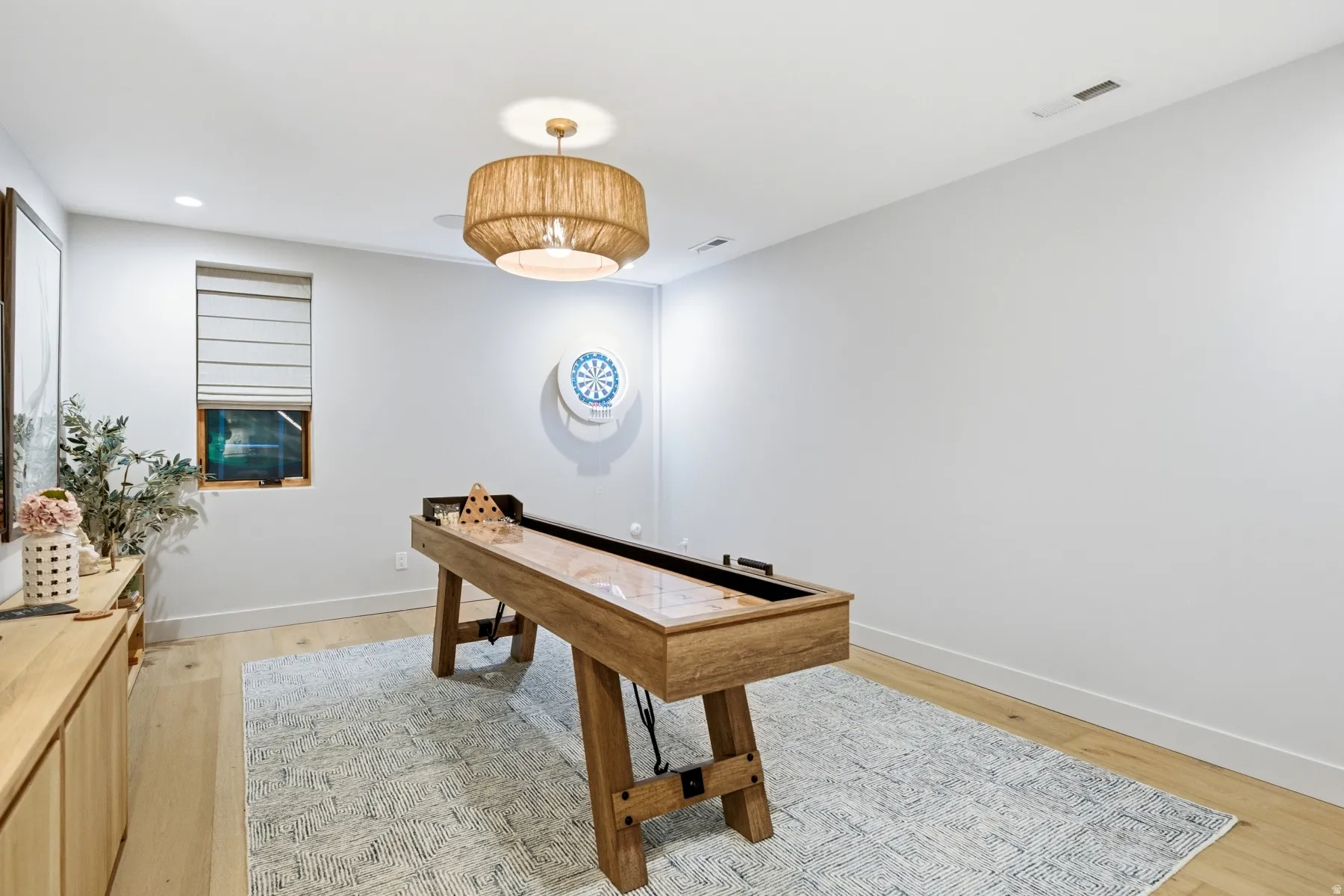 Playroom with light wood-style floors and recessed lighting