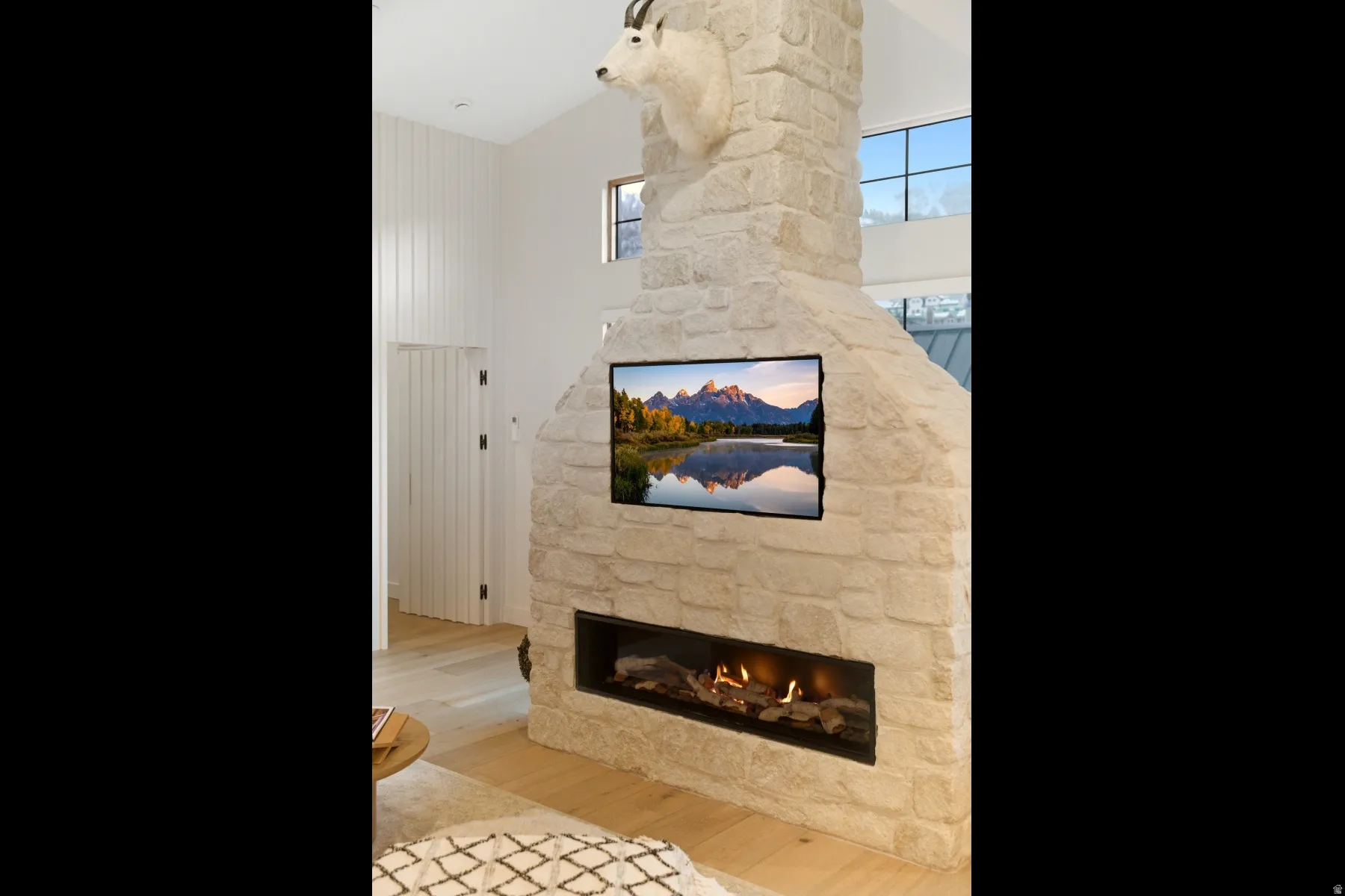 Detailed view of wood finished floors and a fireplace
