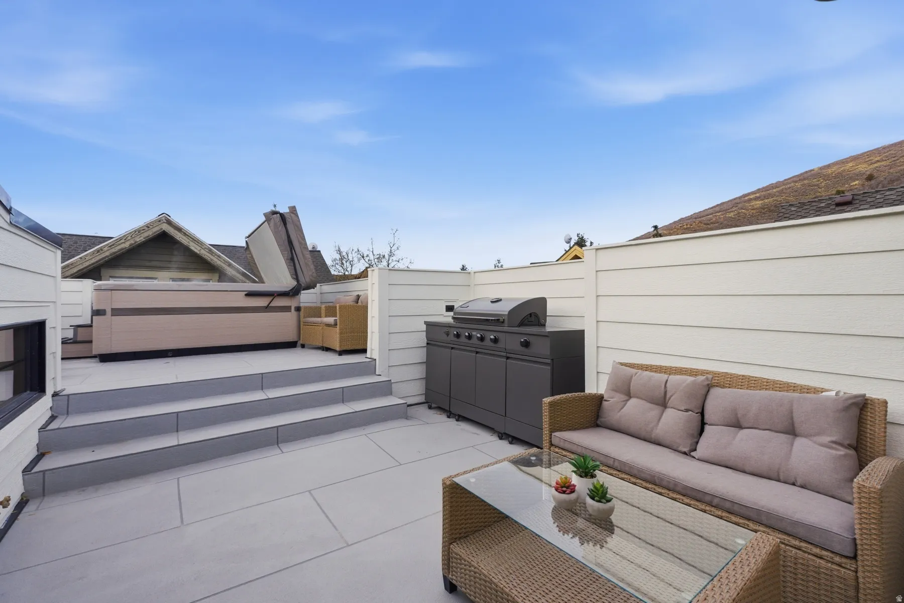 Fenced backyard featuring a patio area, outdoor seating, and grilling area