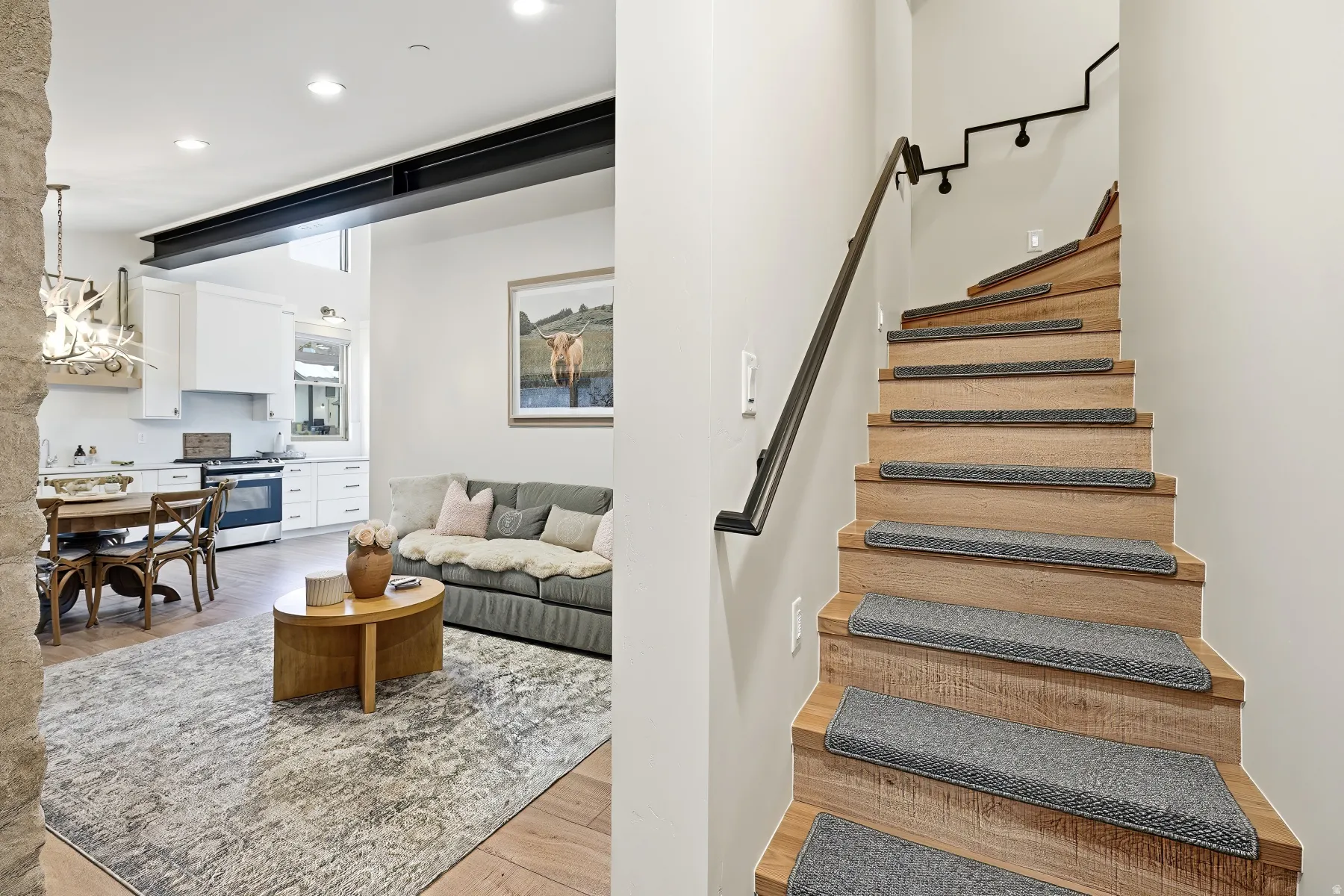 Staircase featuring wood finished floors and recessed lighting