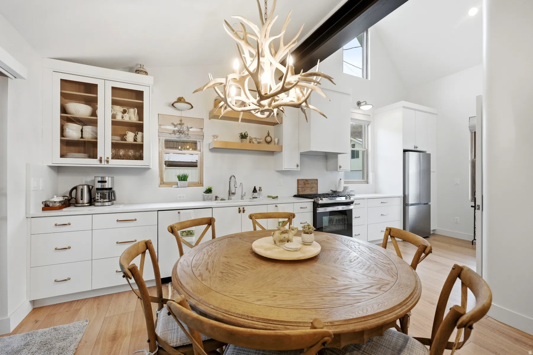 Dining space featuring lofted ceiling, light wood-style flooring, and a chandelier
