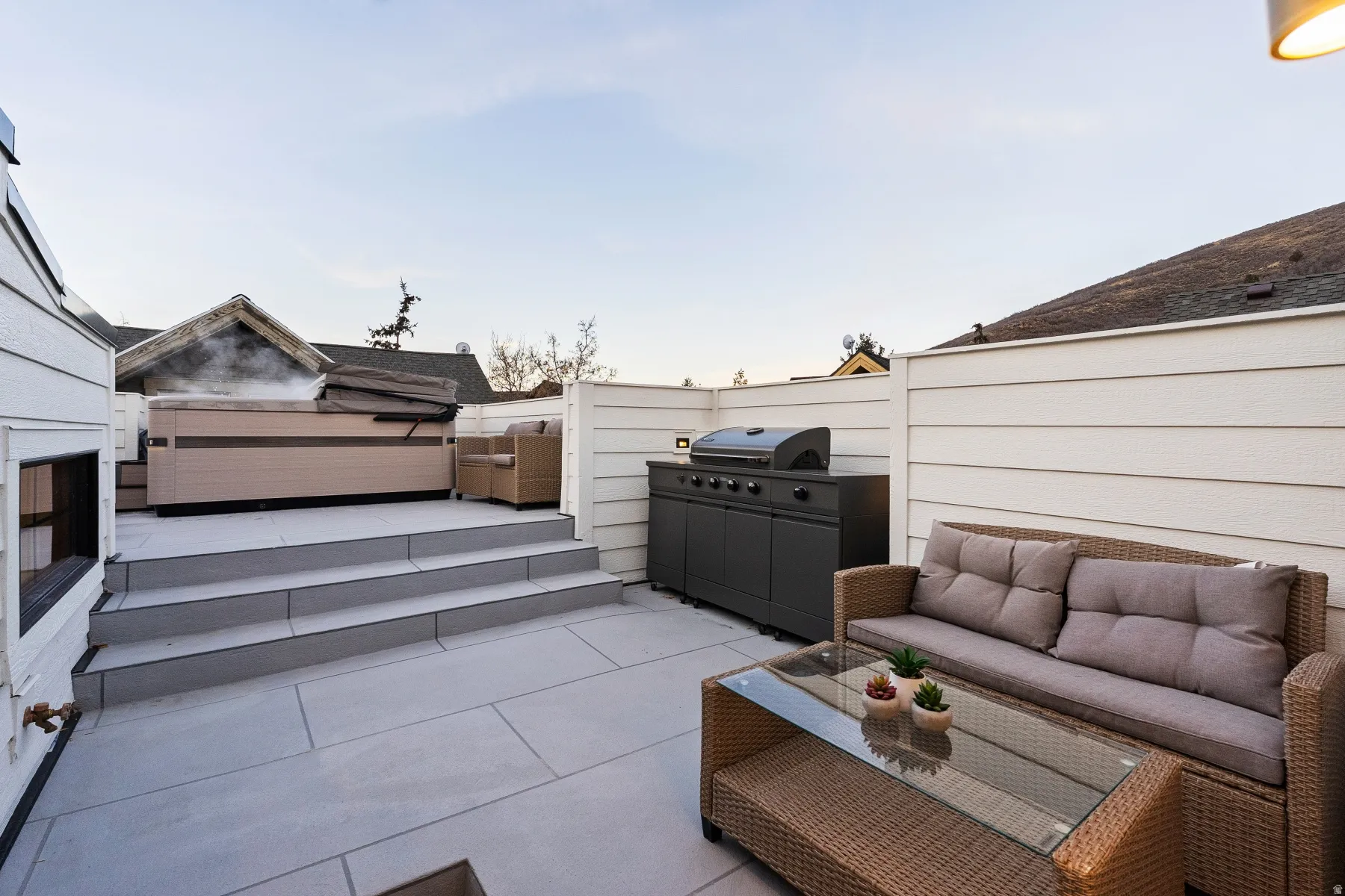 Fenced backyard featuring outdoor furniture