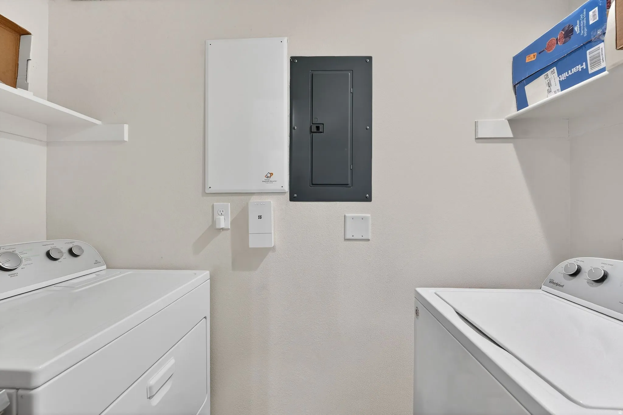 Laundry area with electric panel and independent washer and dryer