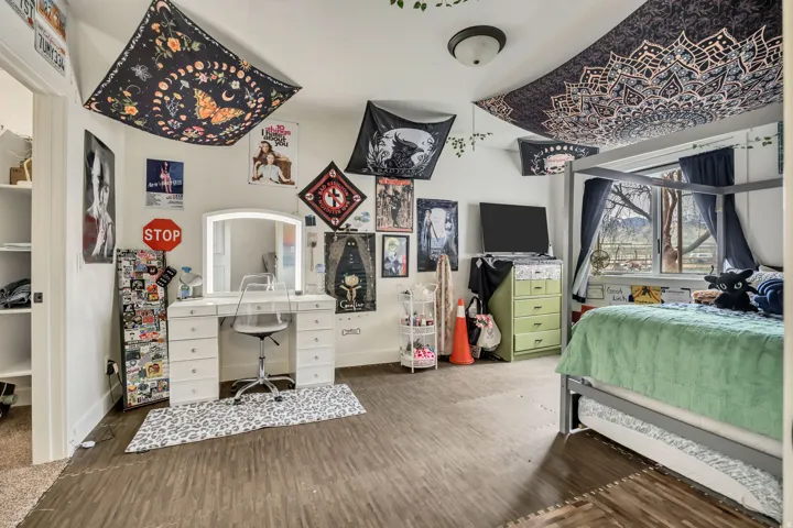 Bedroom with dark wood-style floors and baseboards