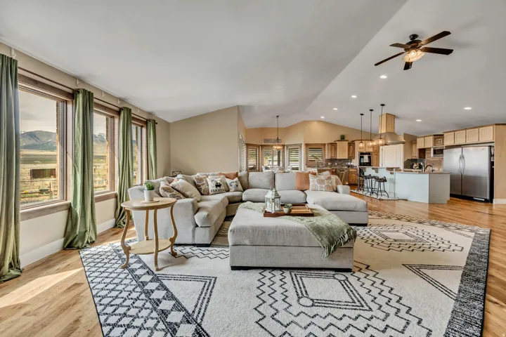 Living area featuring light wood-type flooring, ceiling fan, and recessed lighting