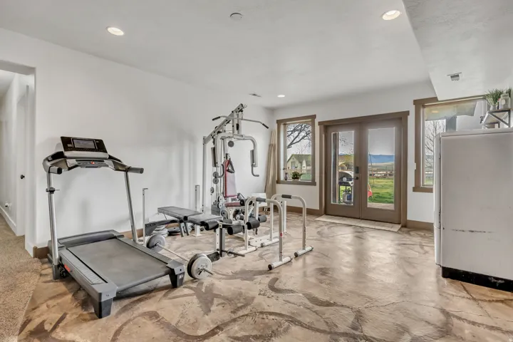 Exercise area featuring french doors and recessed lighting