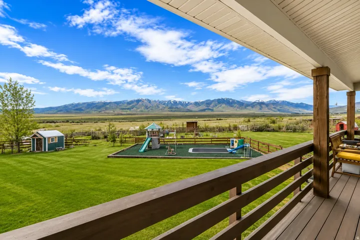 Expansive outdoor deck with wood-finish flooring and solid wood support columns