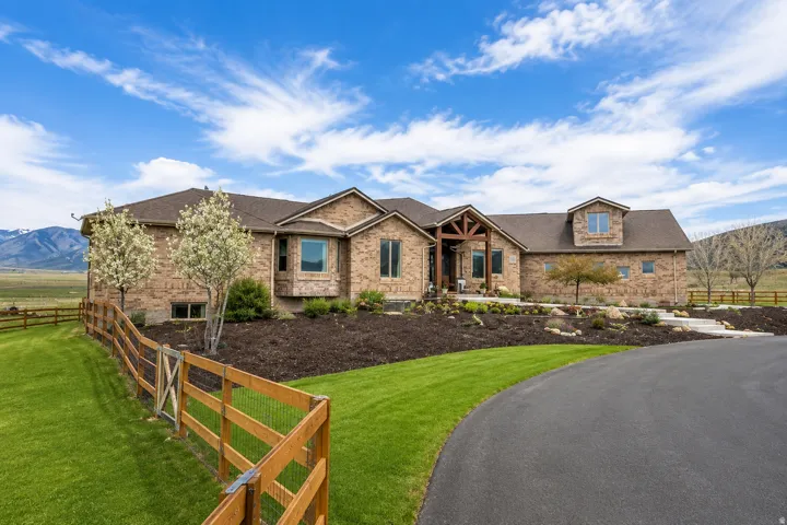 Brick exterior residence with a prominent wooden porch entry
